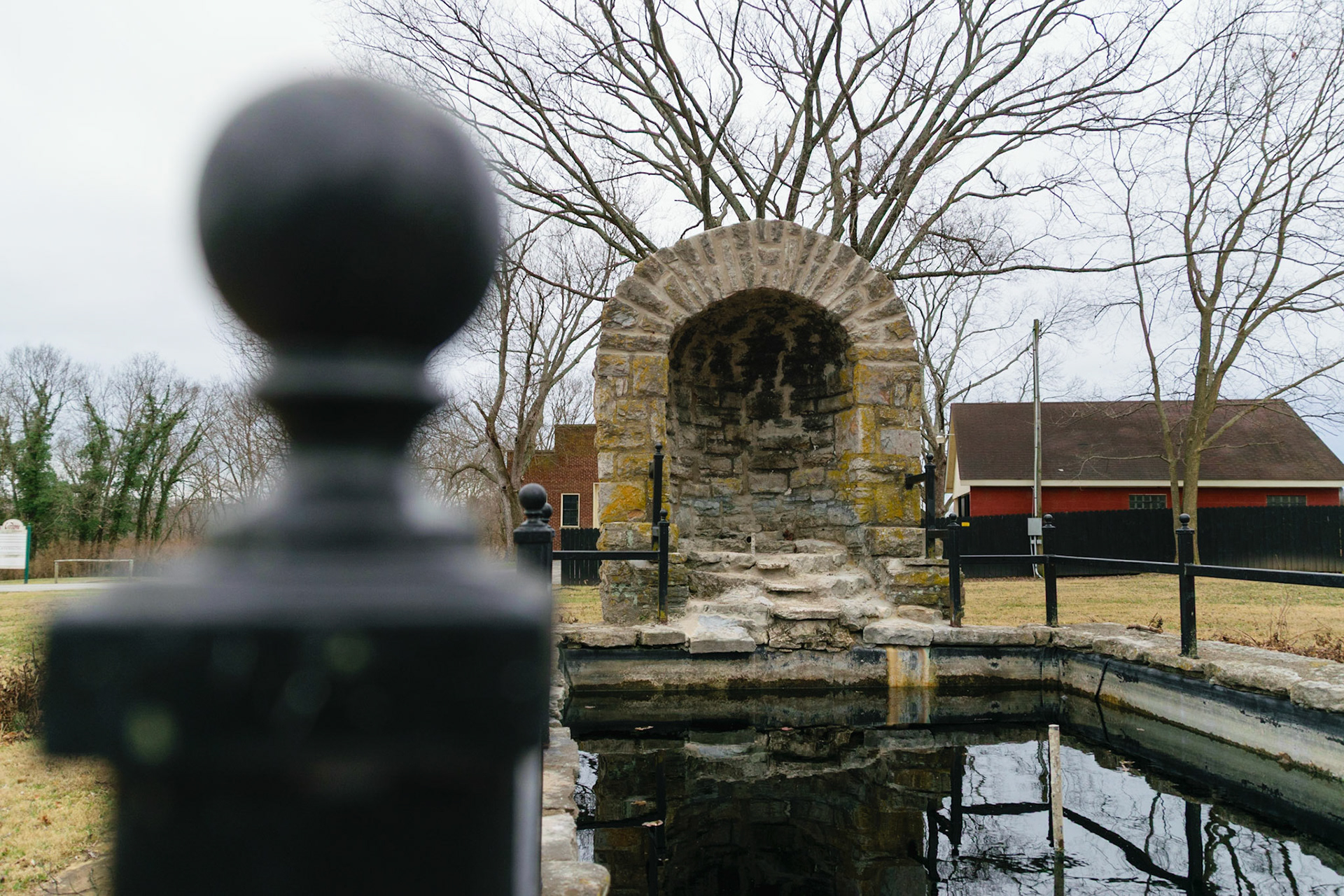 A old delapidated fountain must have once held some sort of statuesque water feature.