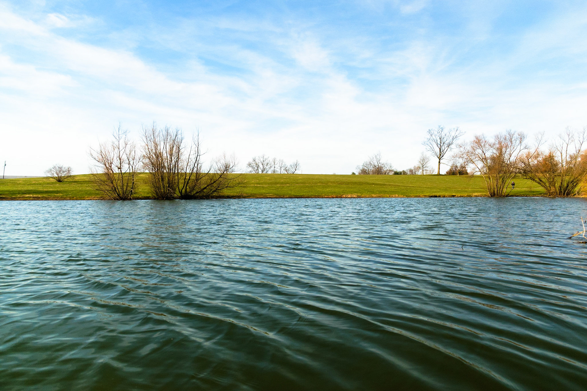 The still waters reflect the blue sky.