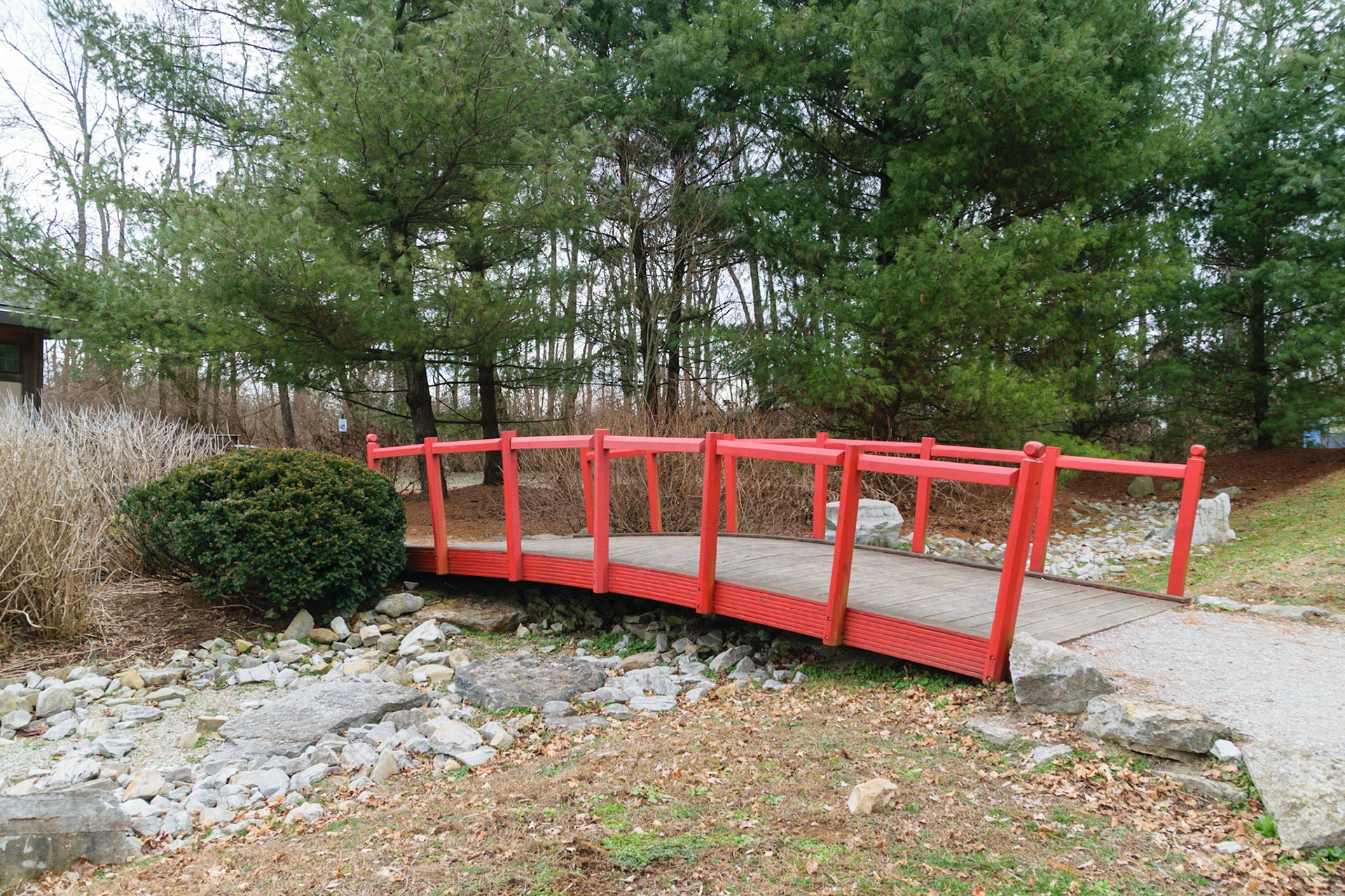 A small red bridge protects the small rocks below.