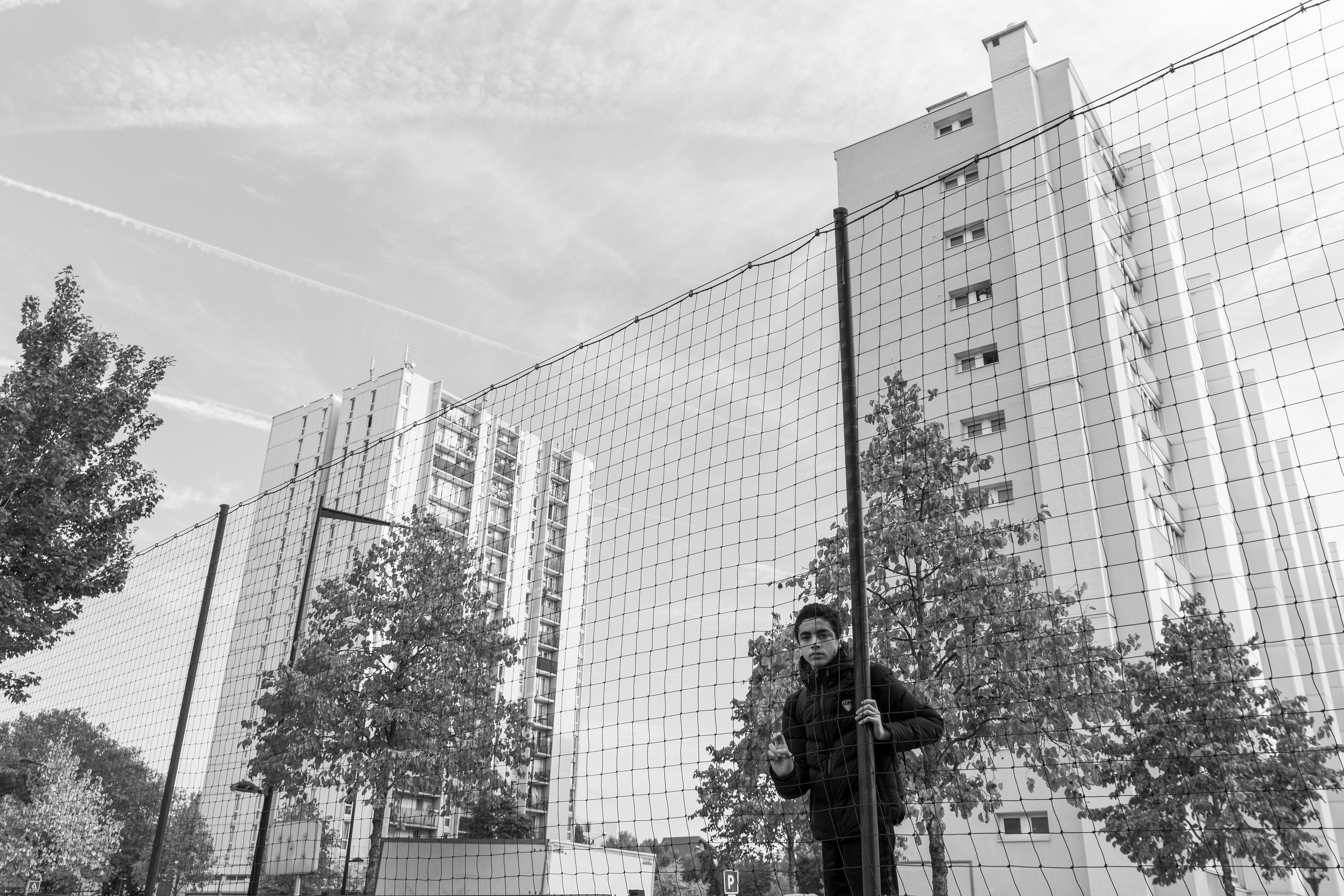 Boy watching a football game in Aubervilliers, France