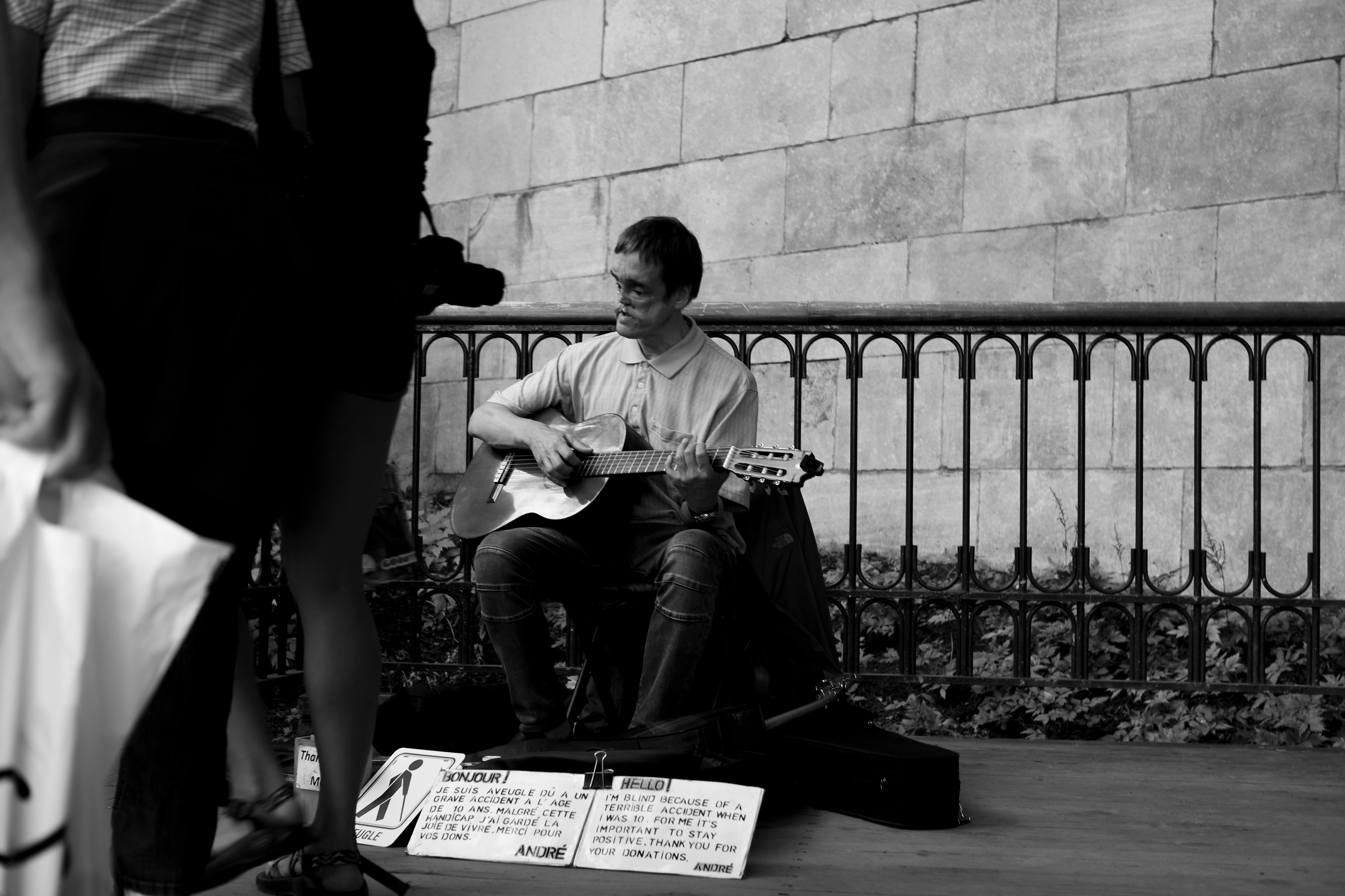 Disabled man playing guitar in the street of old Québec City, Québec, August 2019