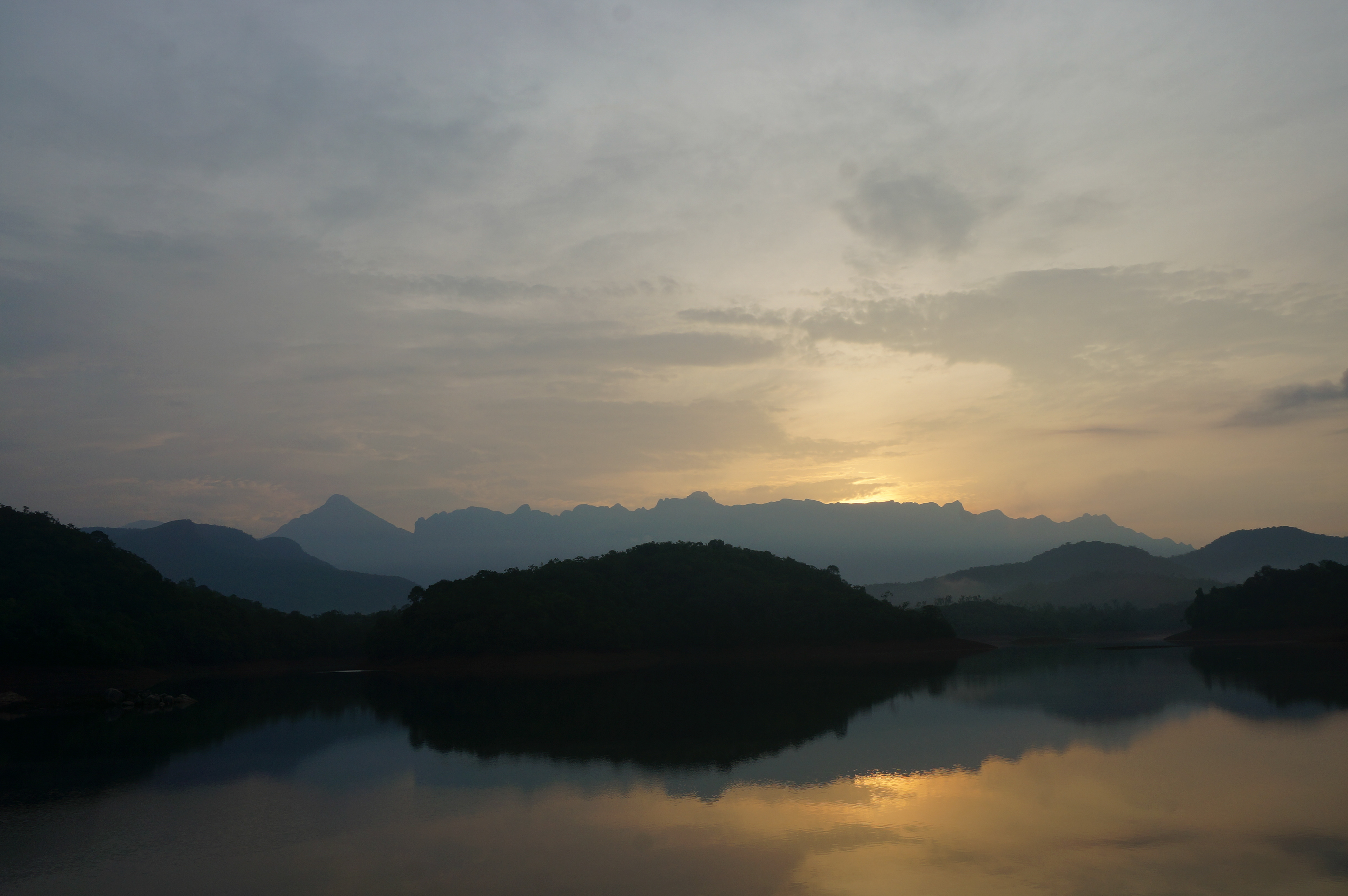 Sunset on the lake near the Dhanwantari Ashram in Neyyar Dam, Kerala. Sivananda Ashram is located near the lake, and silent meditations walks are often organised to the lake