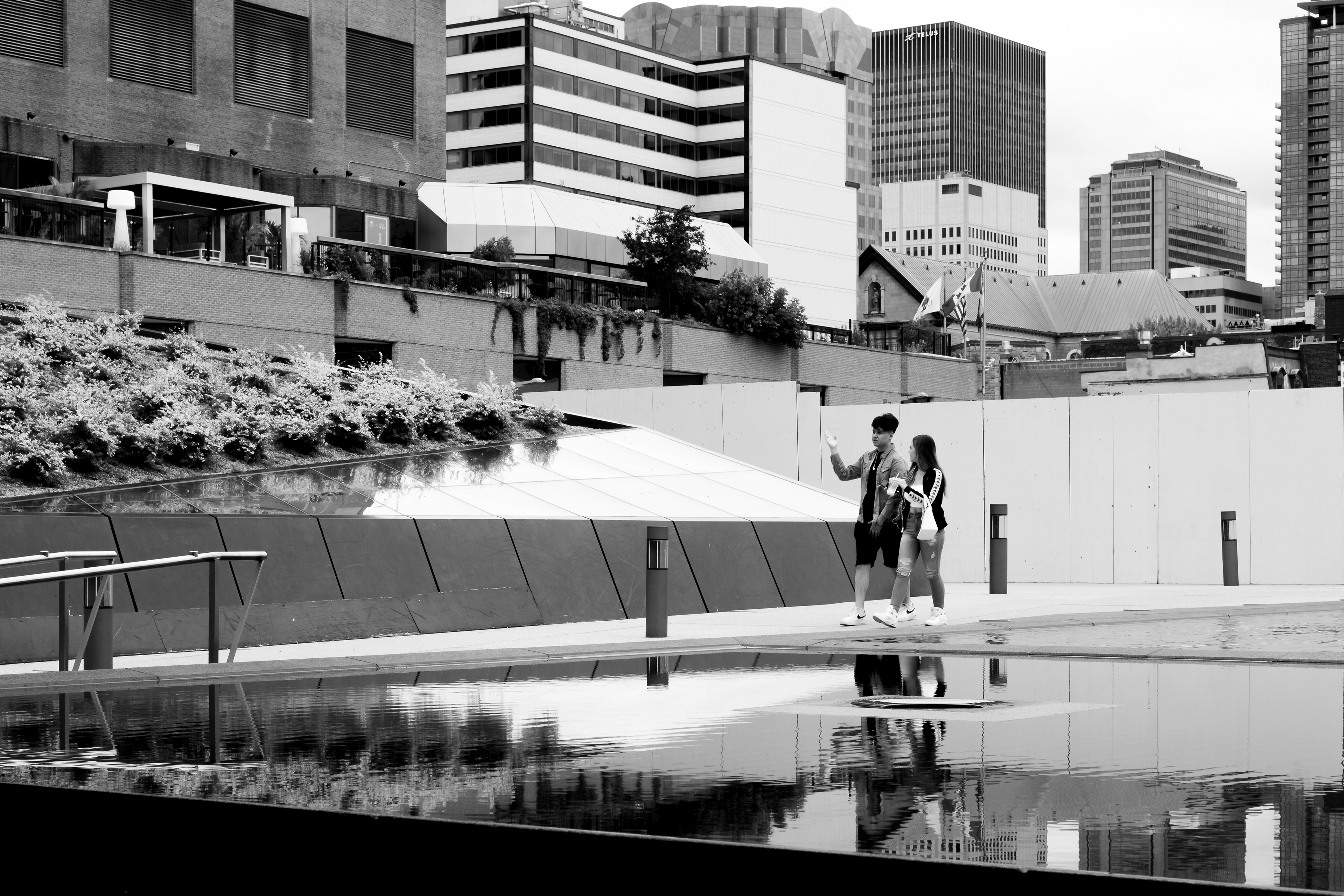 Couple walking in Place des Arts, Montréal, August 2019