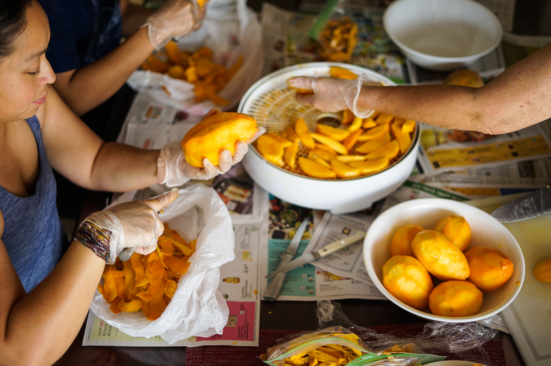 It takes a village to peel and cut mangos.
