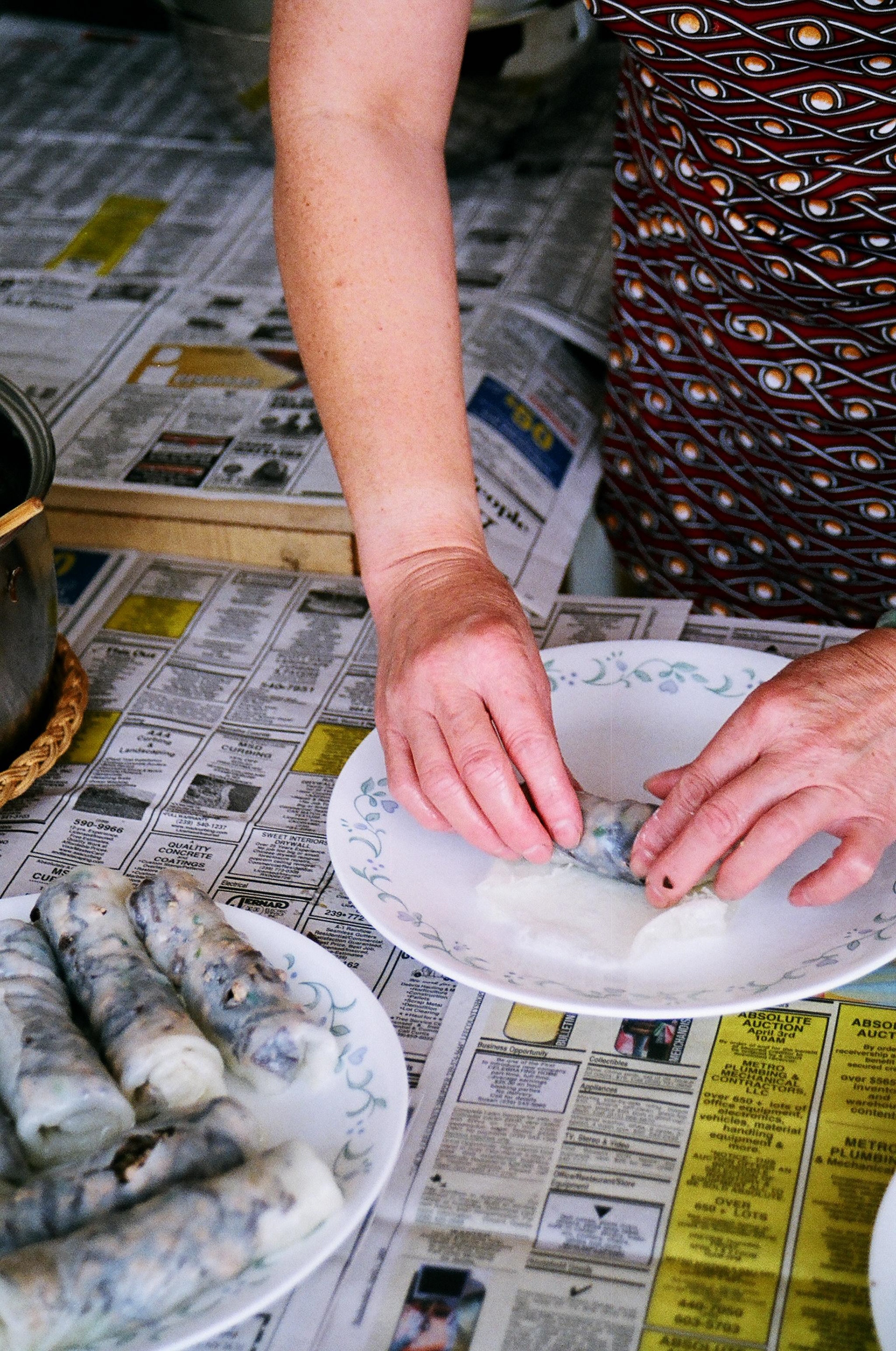 Mom rolls the crépes while more are cooking on the stove.