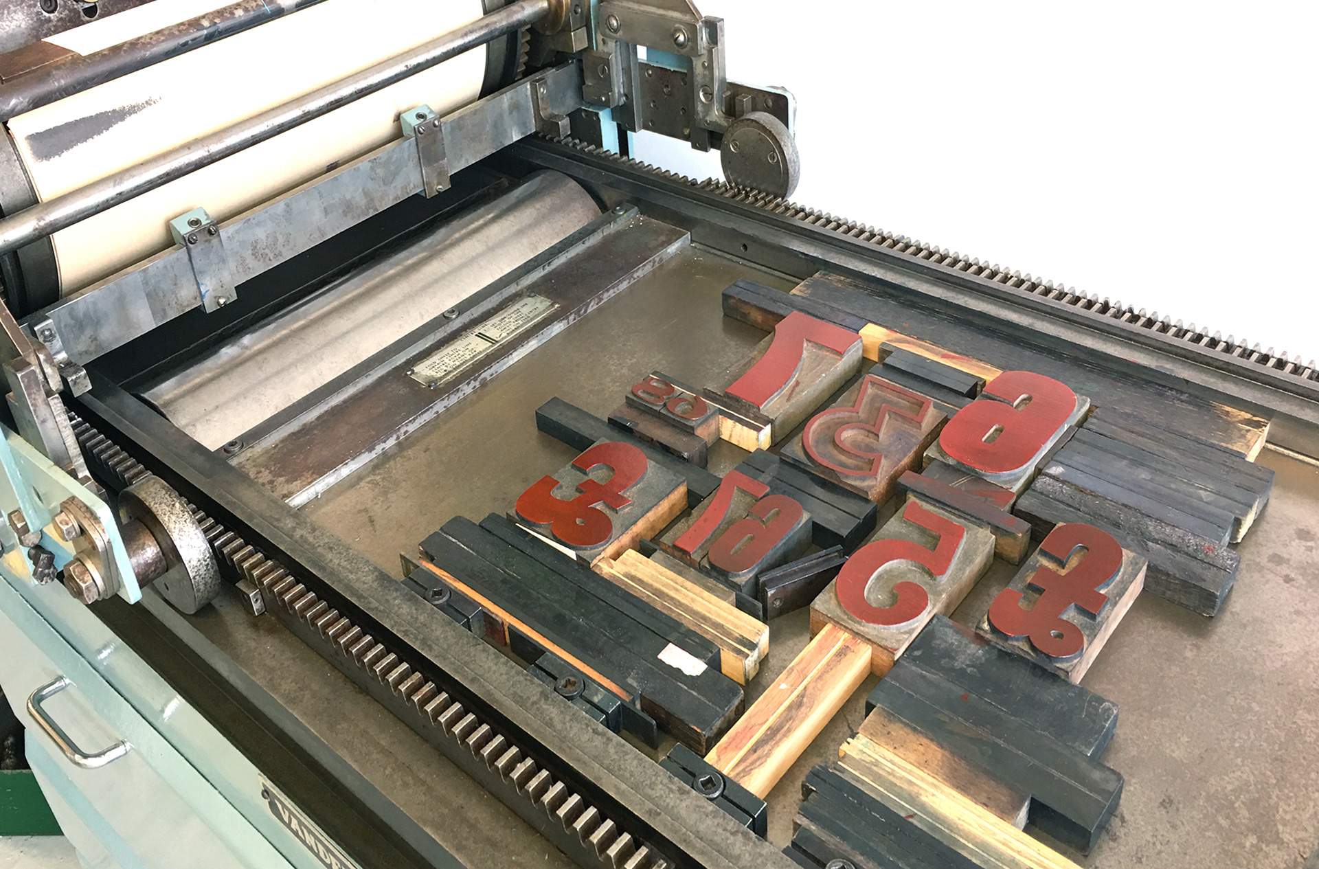 Redpocket Design Studio & Type Tom’s letterpress machine wood type block set up