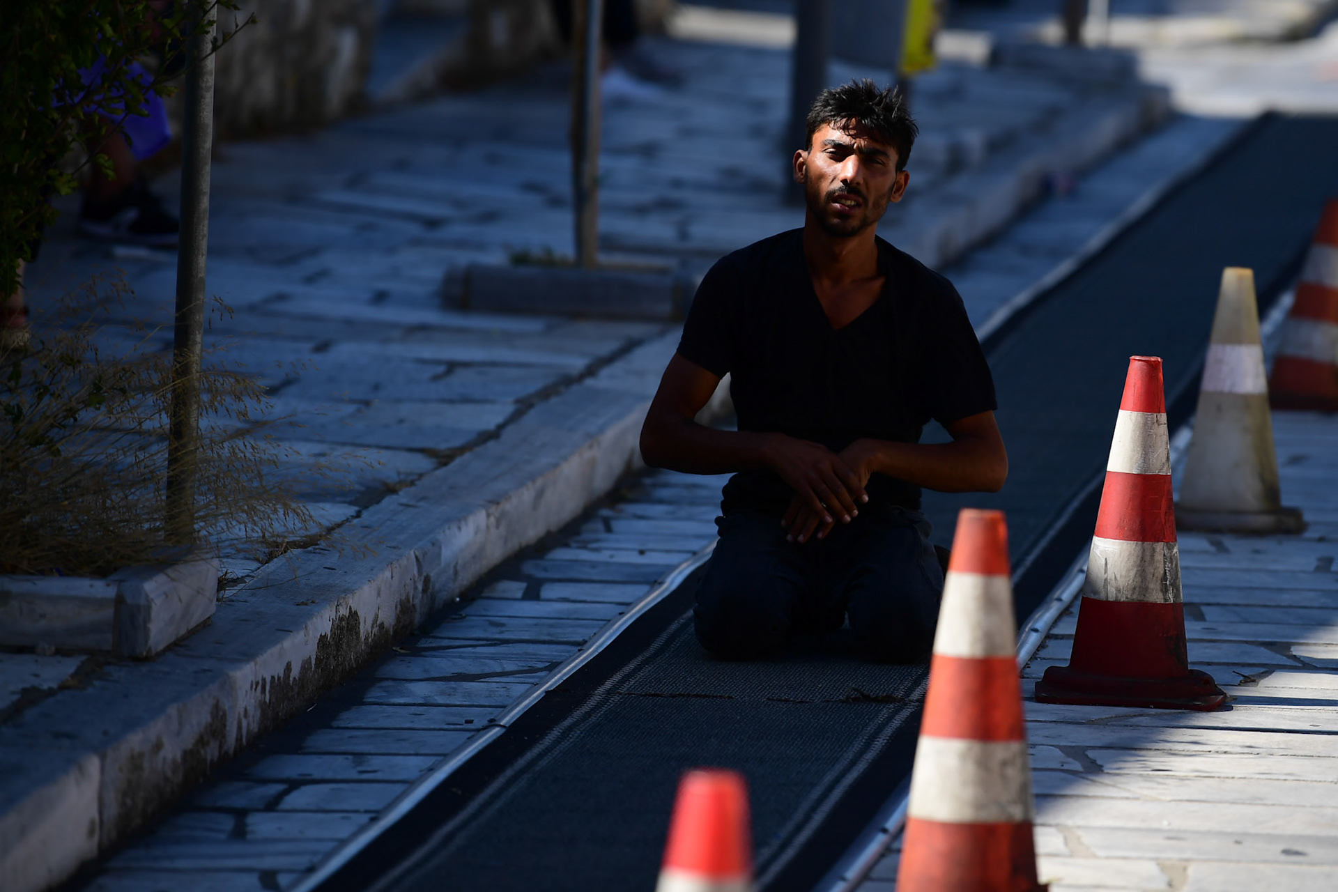 A pilgrim pauses while he crawls his way to the Greek Orthodox Church of Panagia Evaggelistria during the Ascension of Virgin Mary holiday, in Tinos, Greece, Wednesday, Aug. 15, 2018.