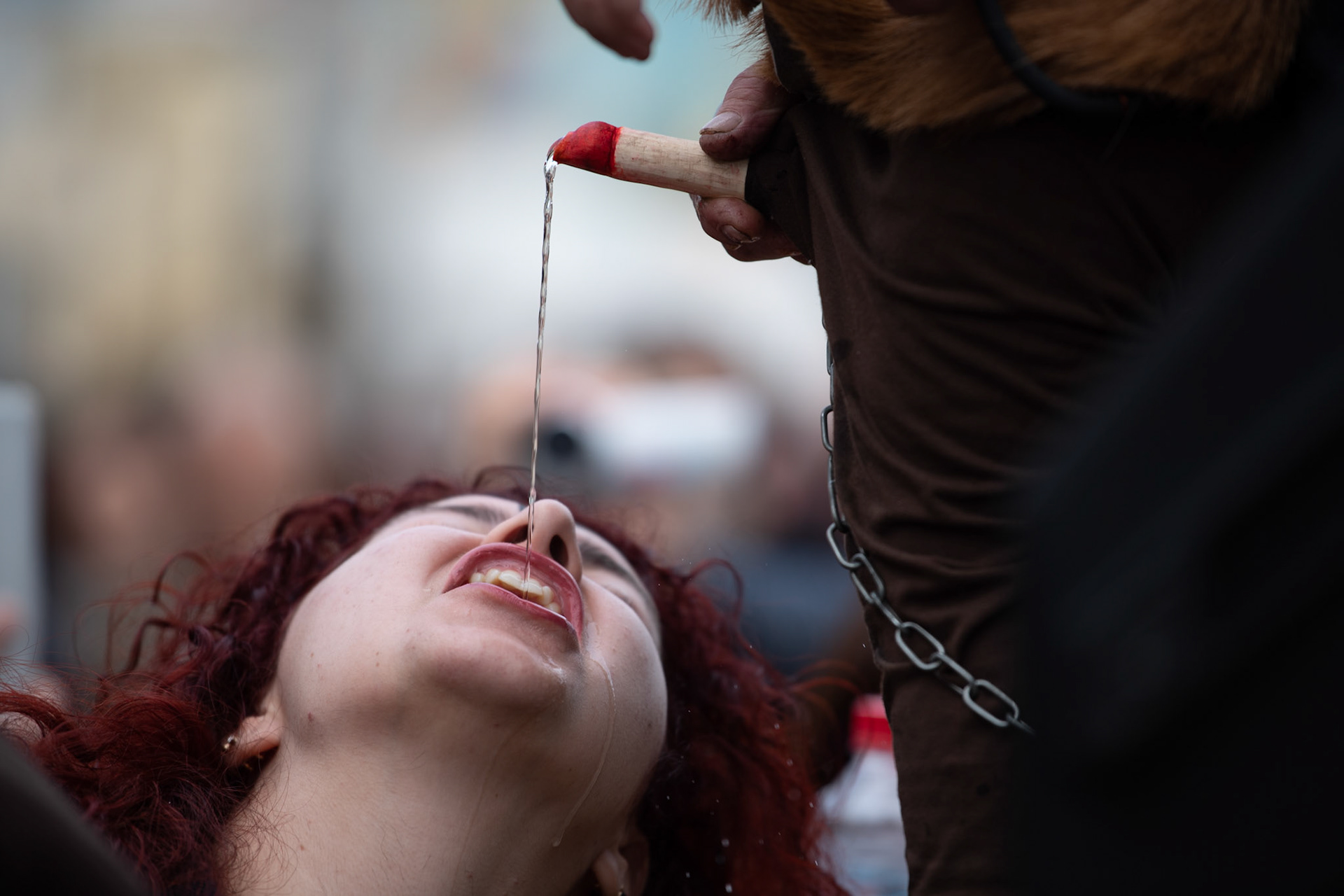 A woman drinks raki, the traditional drink of Crete, from the penis of a satire, during the festivities of Clean Monday, in the village of Yeryeri, Crete, Greece, Monday, Feb. 27, 2017.