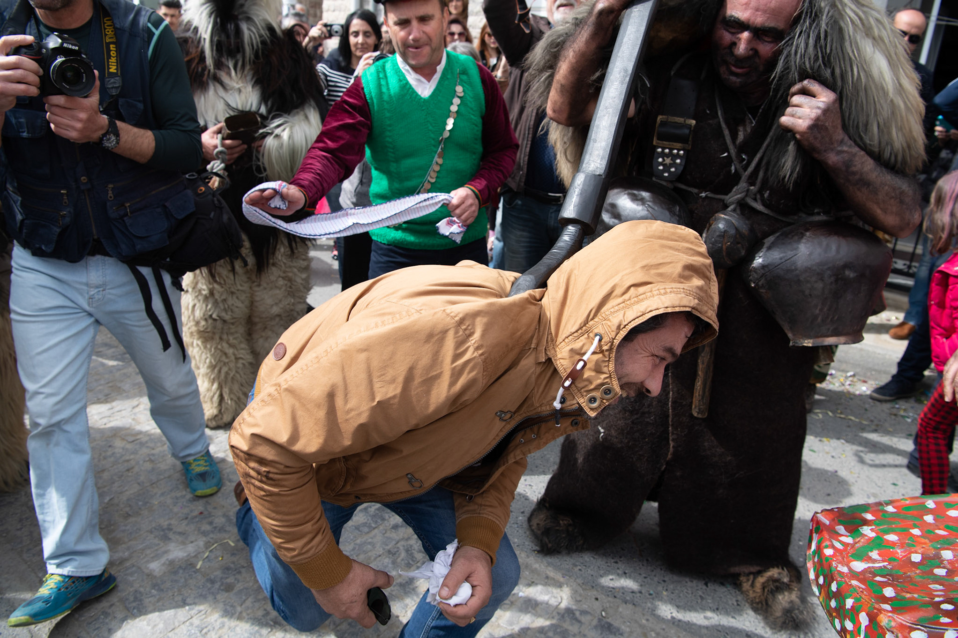 A man is pinned down by an “Arkoudiaris” during the festivities of Clean Monday, in the village of Yeryeri, Crete, Greece, Monday, Feb. 27, 2017.