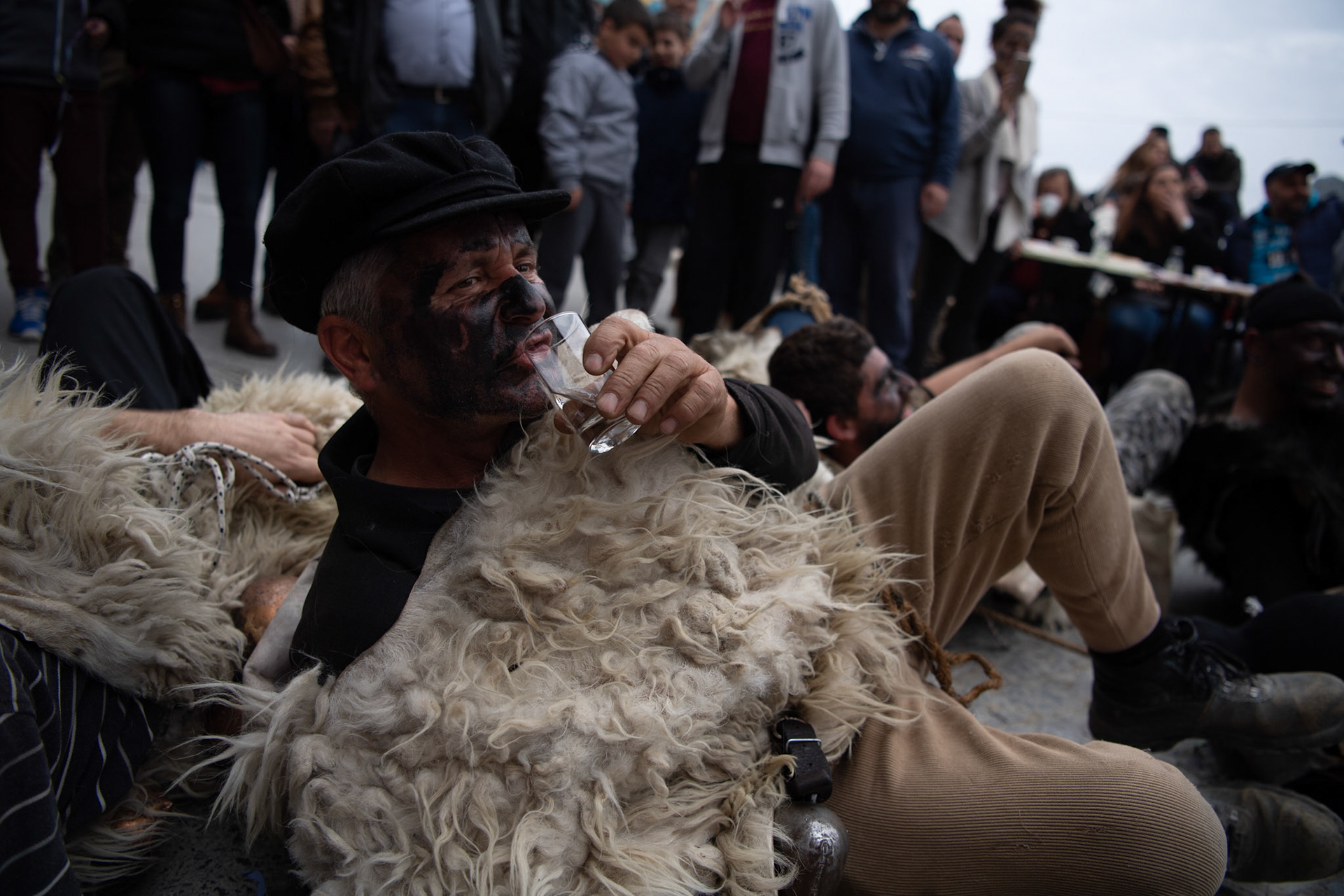 A man dressed as a sheperd drinks raki, the traditional drink of Crete, during the festivities of Clean Monday, in the village of Yeryeri, Crete, Greece, Monday, Feb. 27, 2017.