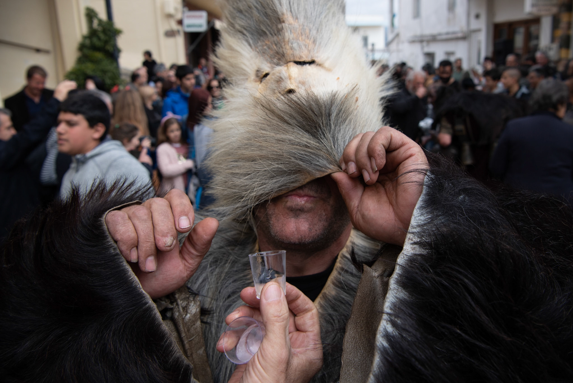 A man dressed as an “Arkoudiaris” prepares to drink raki, traditional drink of Crete, during the festivities of Clean Monday, in the village of Yeryeri, Crete, Greece, Monday, Feb. 27, 2017.