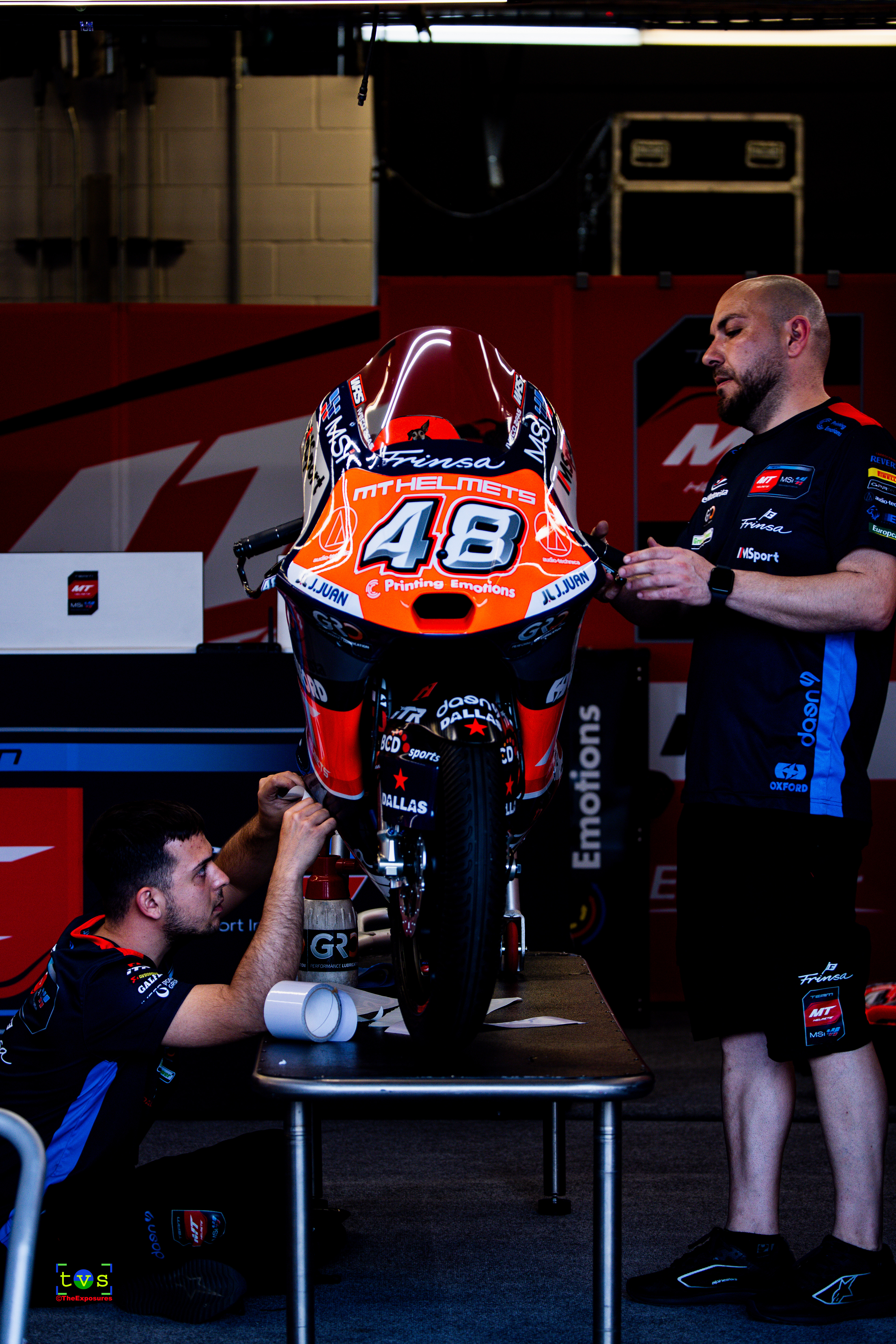 Details Matter - Mechanics installing decals on the bike
