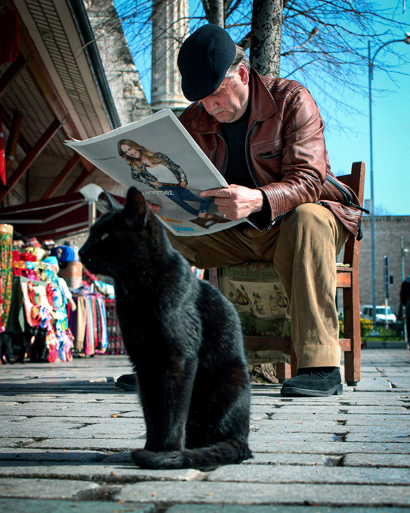 Gift store owner reading a newspaper - Istanbul, Turkey © Fotis Providas