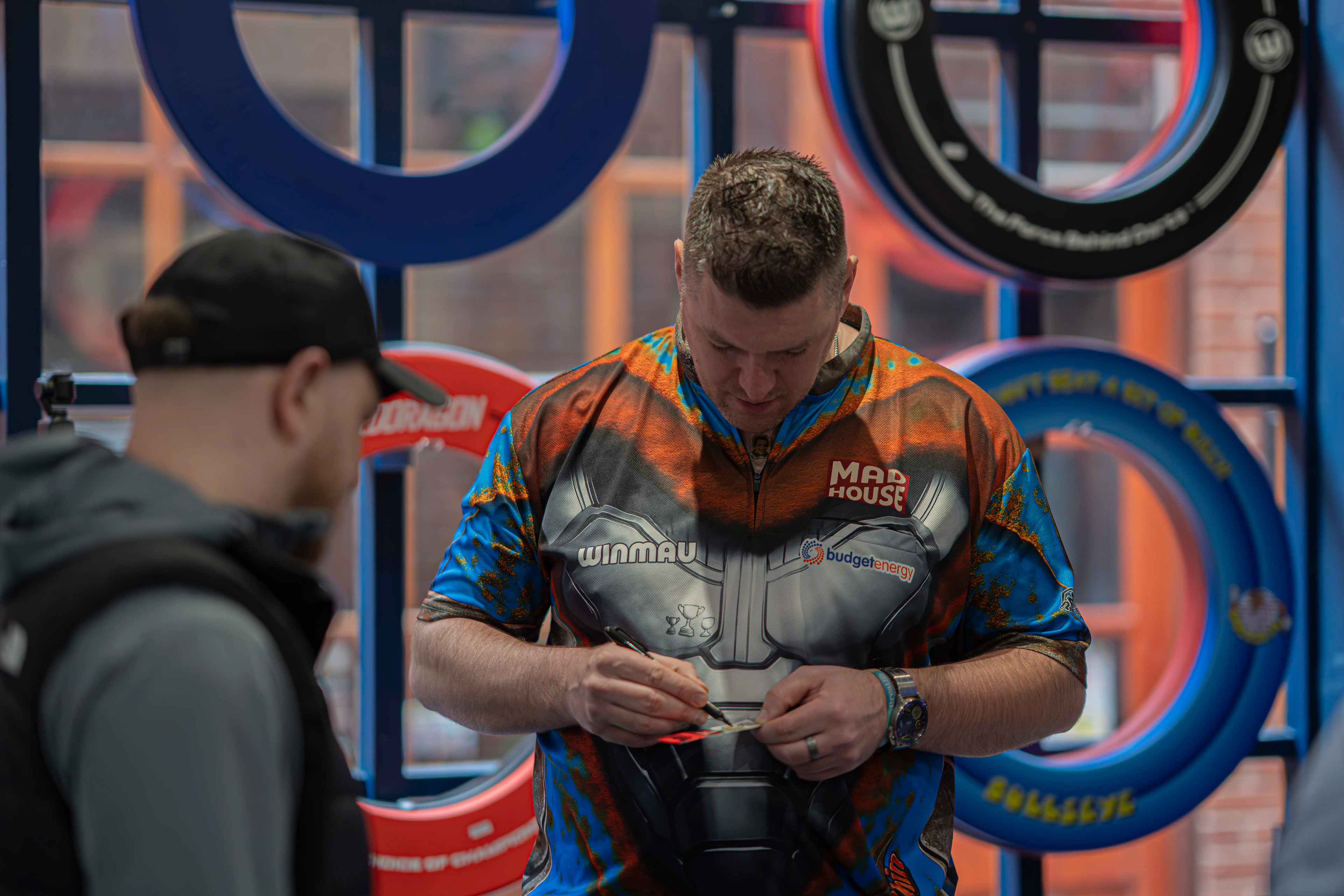 PDC pro Daryl Gurney signing a box of darts for fans at Midlands Darts Shop, Tamworth, Staffordshire. 1st March 2026