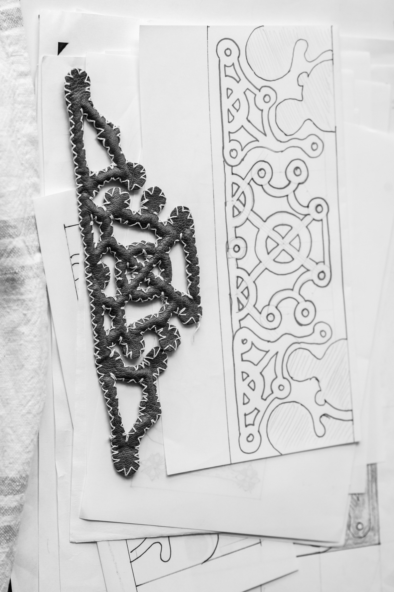 Leather element for cover and its preliminary sketch.