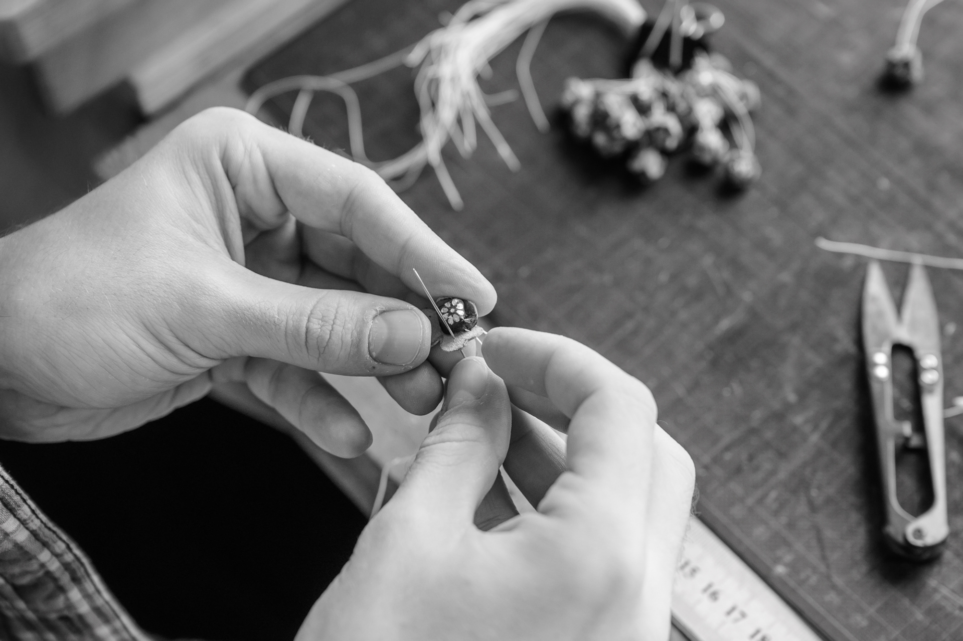 Sewing on a gilded leather trim (for book cover)