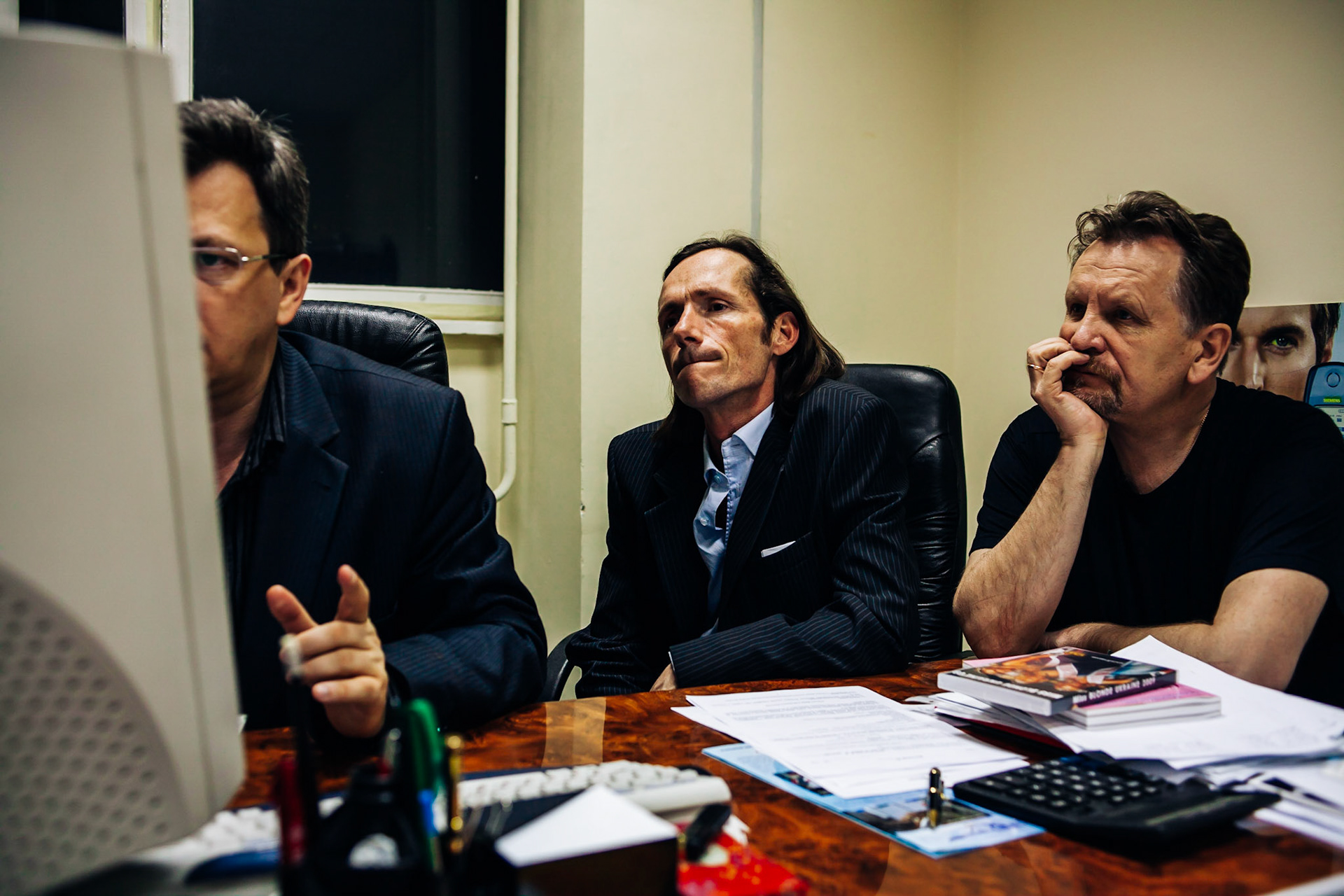 From left to right, local girls "manager", Frederic and Alexander. At night in a strange empty office, the local manager is showing around 5000 girls on the internet to the two others, trying to sell them for Paris and Mademoiselle fashion models agency.