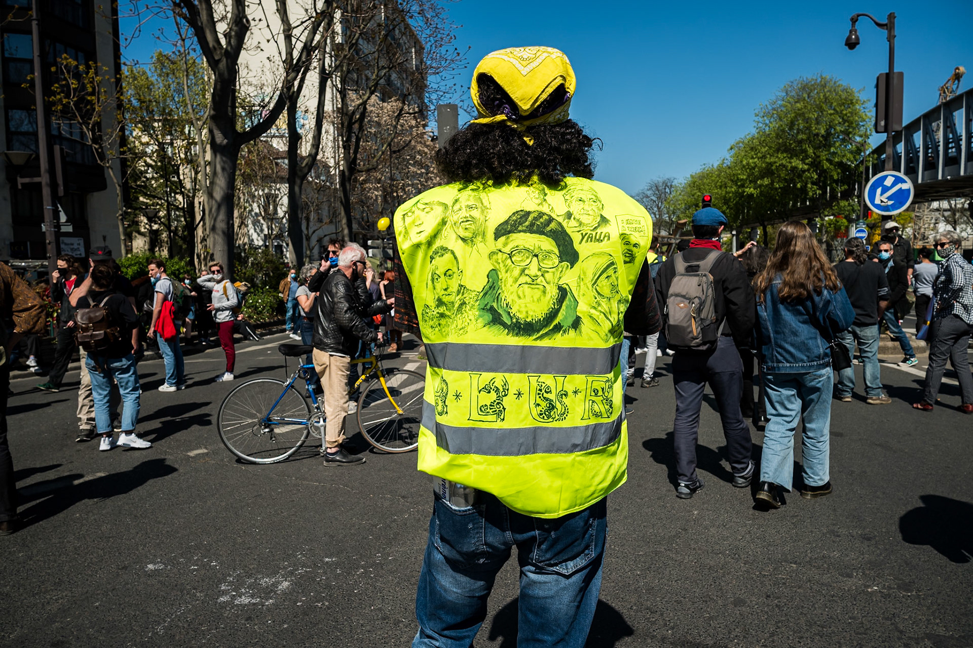 Un manifestant "gilet jaune" porte les visages de l'abbé Pierre et de Coluche sur son gilet. - Manifestation pour la culture du 23 avril 2021, à Paris, entre la place d'Italie et la Bastille.