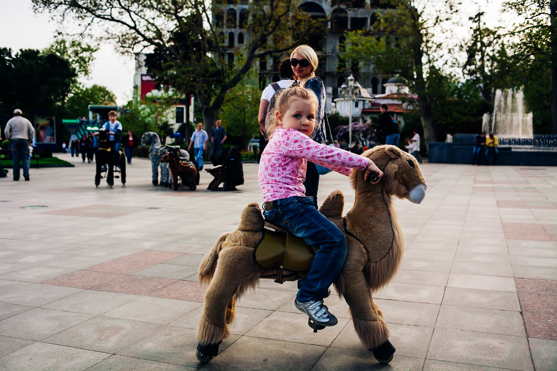 Child riding toy horse in Yalta, Ukraine. A journey through the eyes of Frederic Leonard, a head hunter for "new faces", who scouts fresh young Eastern girls who are to become fashion models. Yalta, Ukraine.