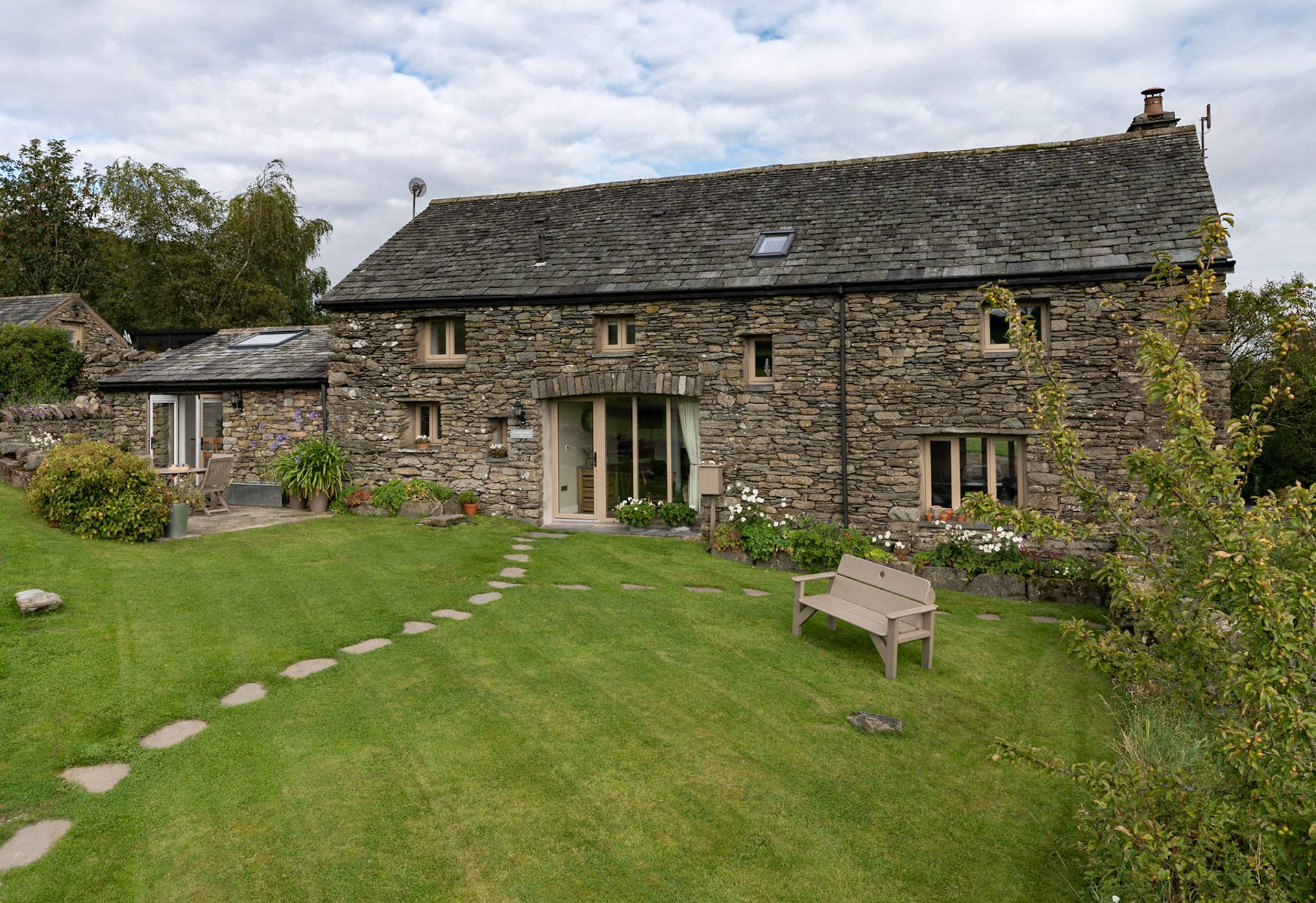 A striking exterior image highlighting the architecture and surroundings of this stunning Cumbria property