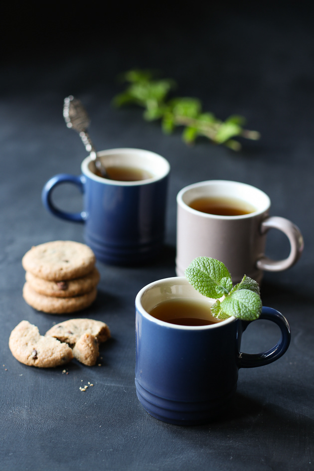3 cups of tea with biscuits