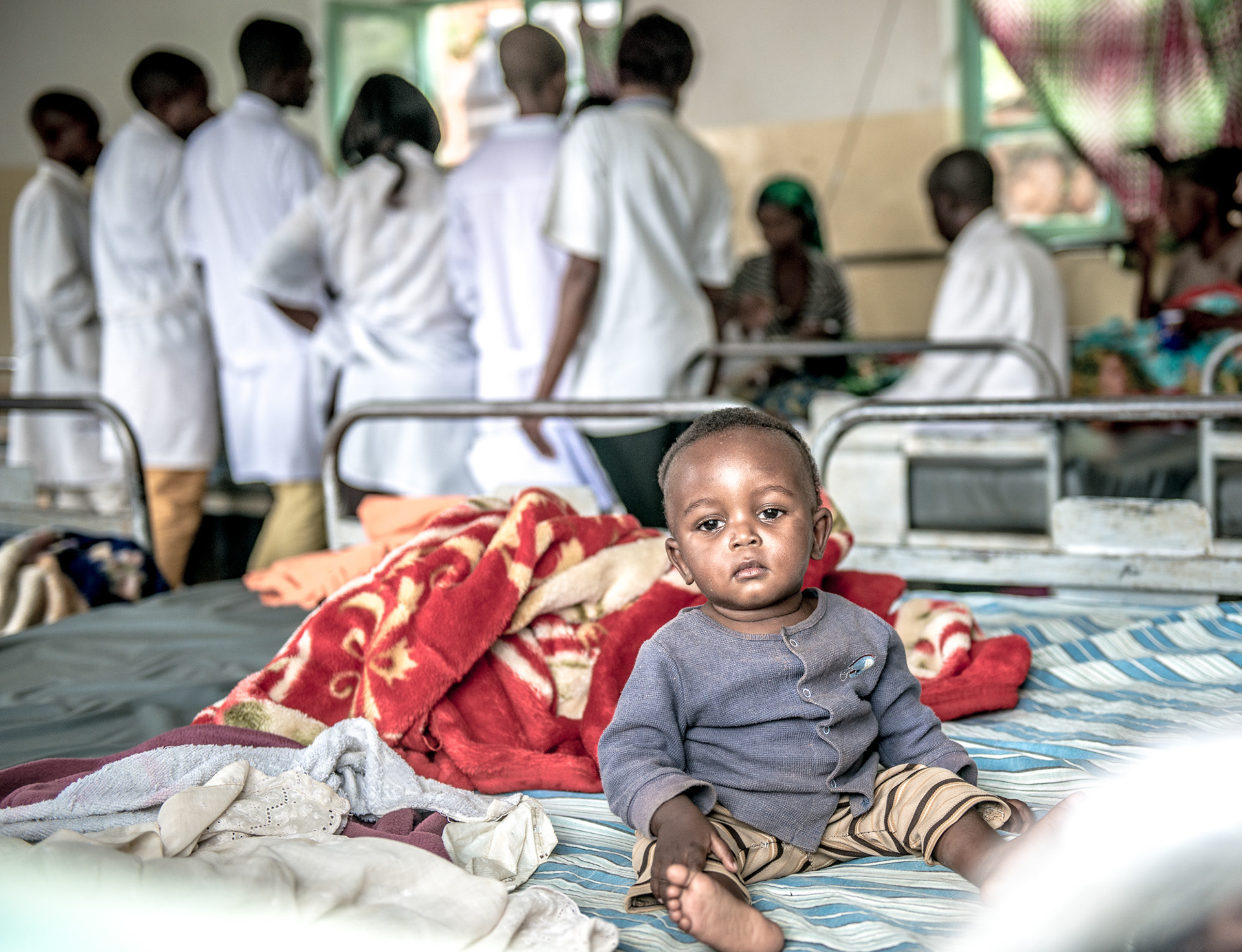 Young boy and medical staff at Chahi Hospital, DRC