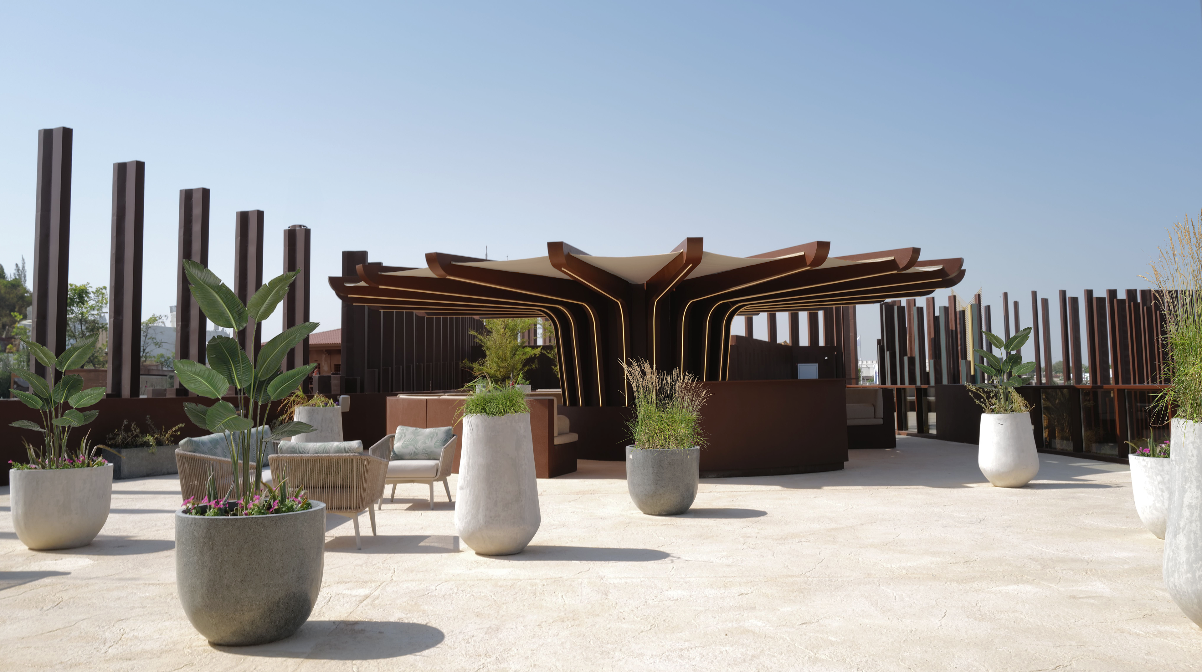 The wide, sunlit terrace with a sunshade covering the VIP area.