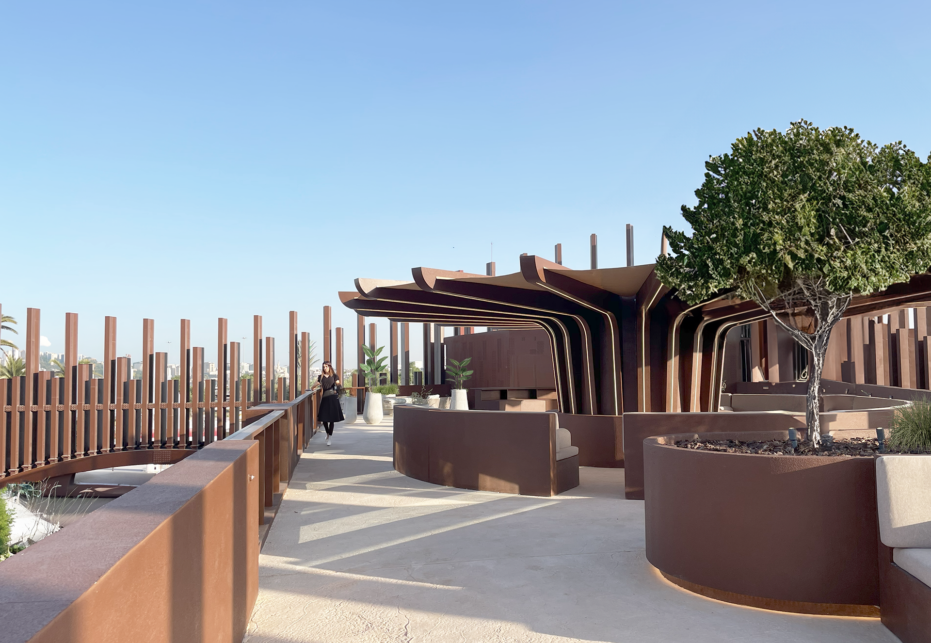 The wide, sunlit terrace with a sunshade covering the VIP area.