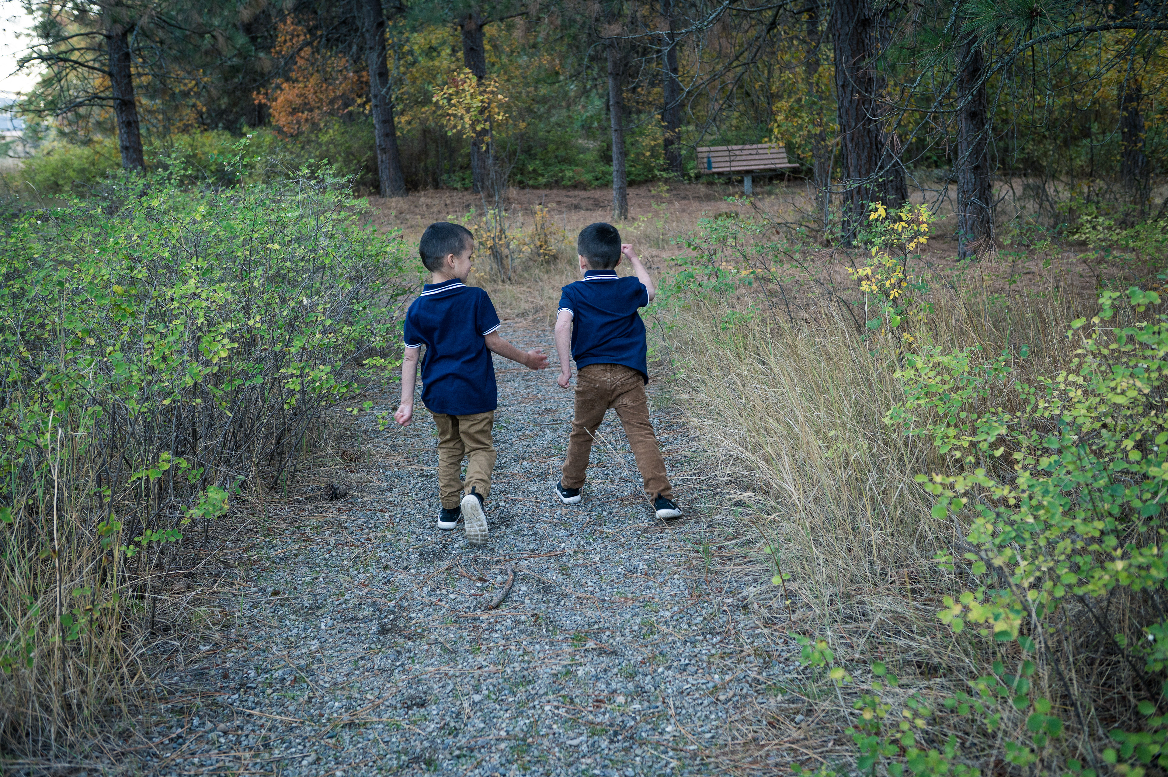 Twin boys walking on a trail