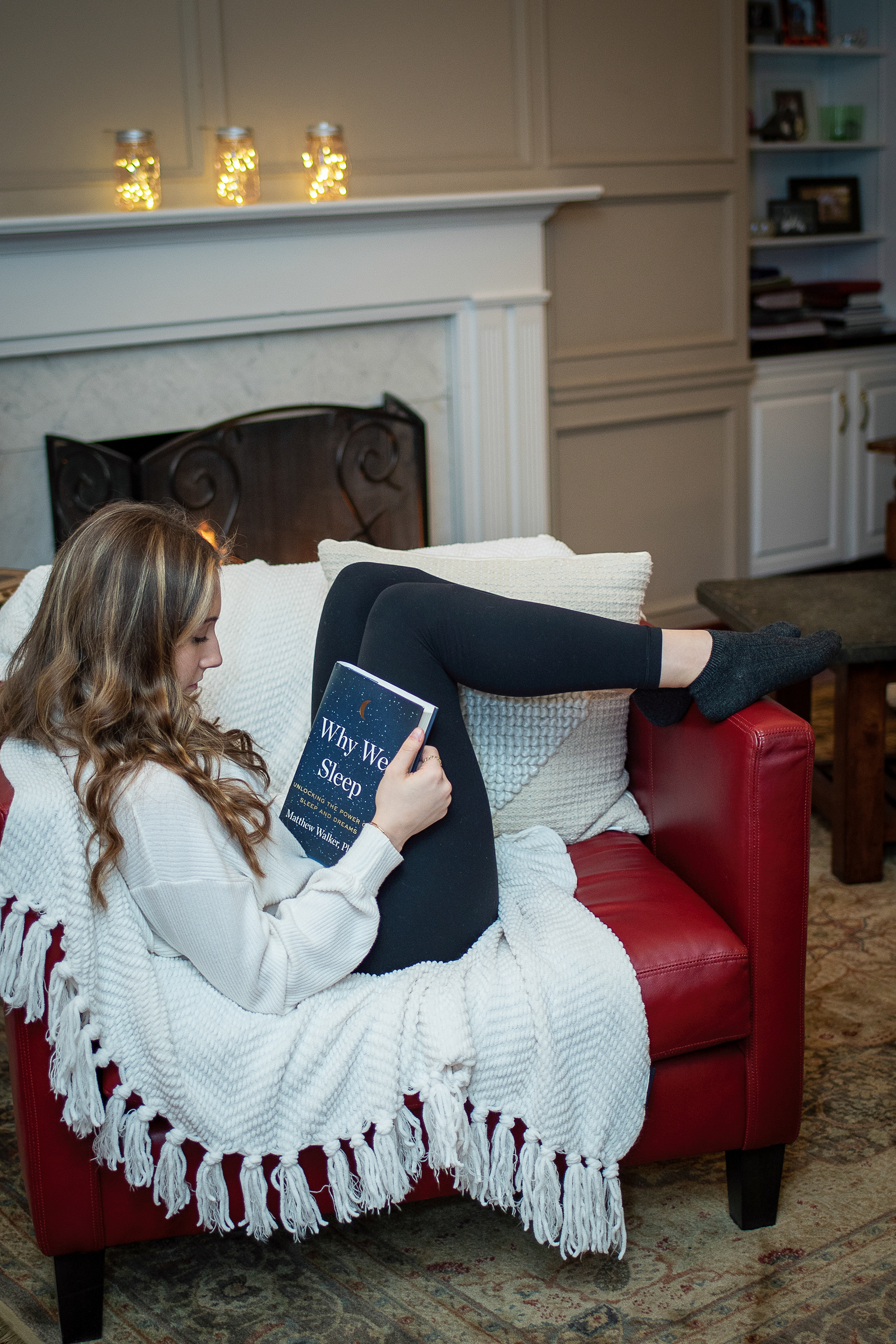 Girl reading by the fire
