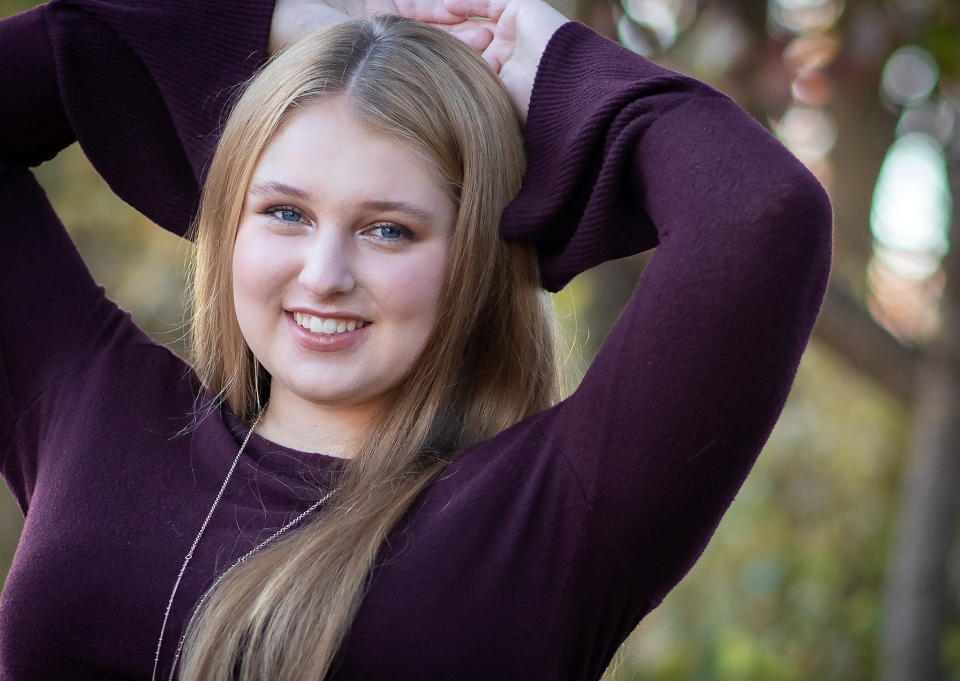 high school senior girl in purple sweater