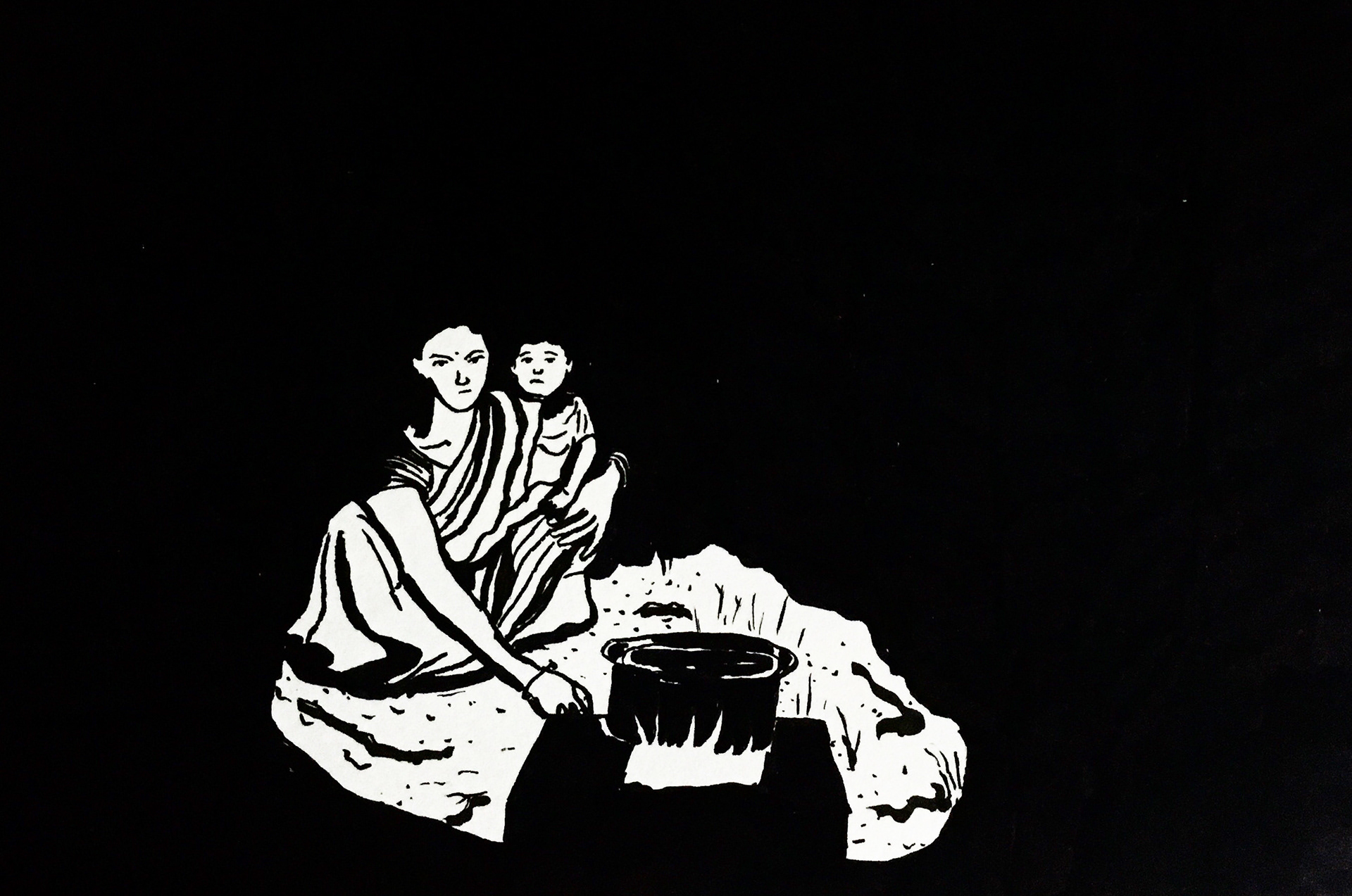 48 - A young migrant mother cooks food by the roadside in Jalandhar, Punjab, while waiting to board a special train to her home in Jharkhand.  