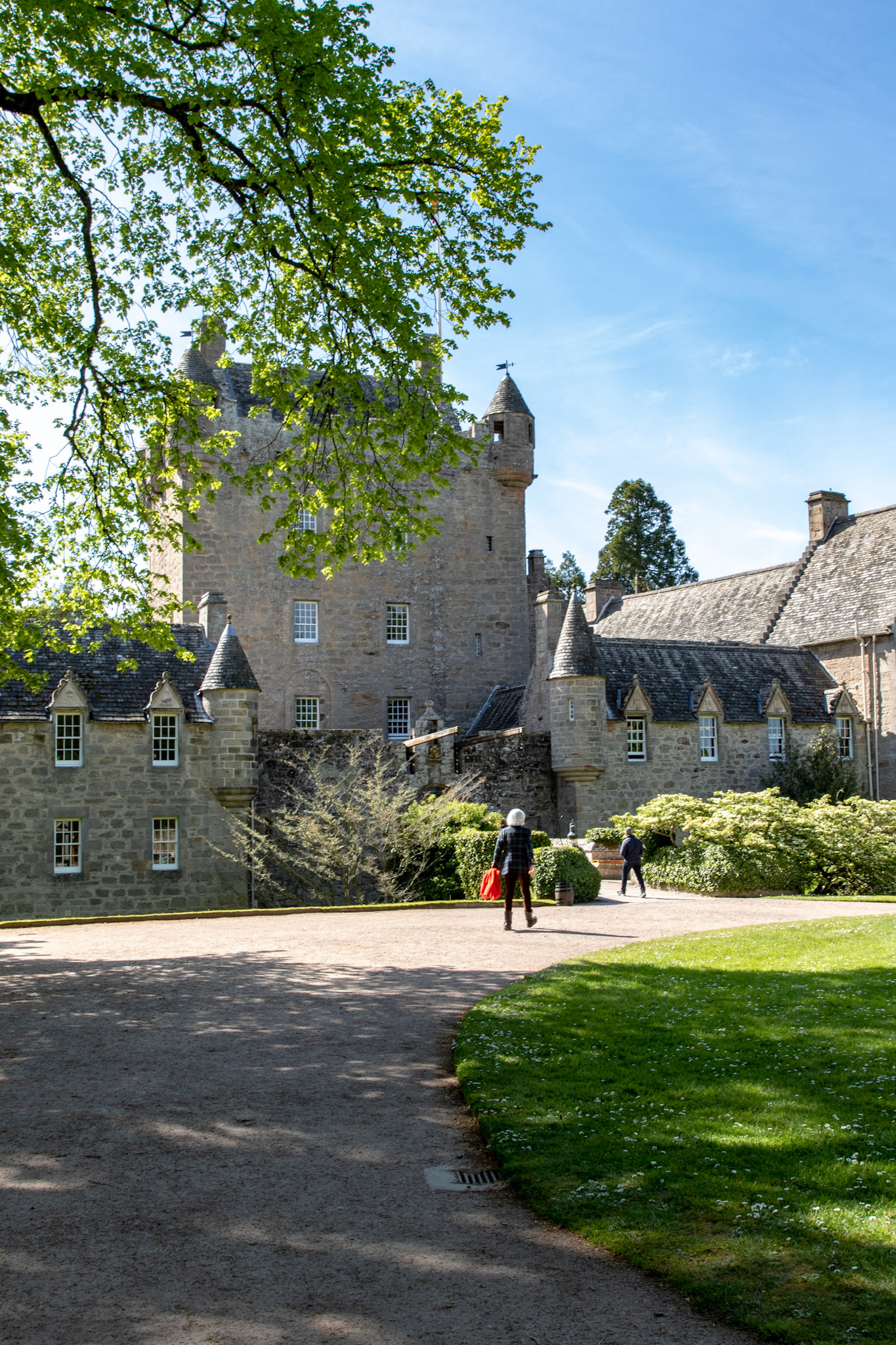 Cawdor Castle with Lady Cawdor in tweed coat holding a red coat