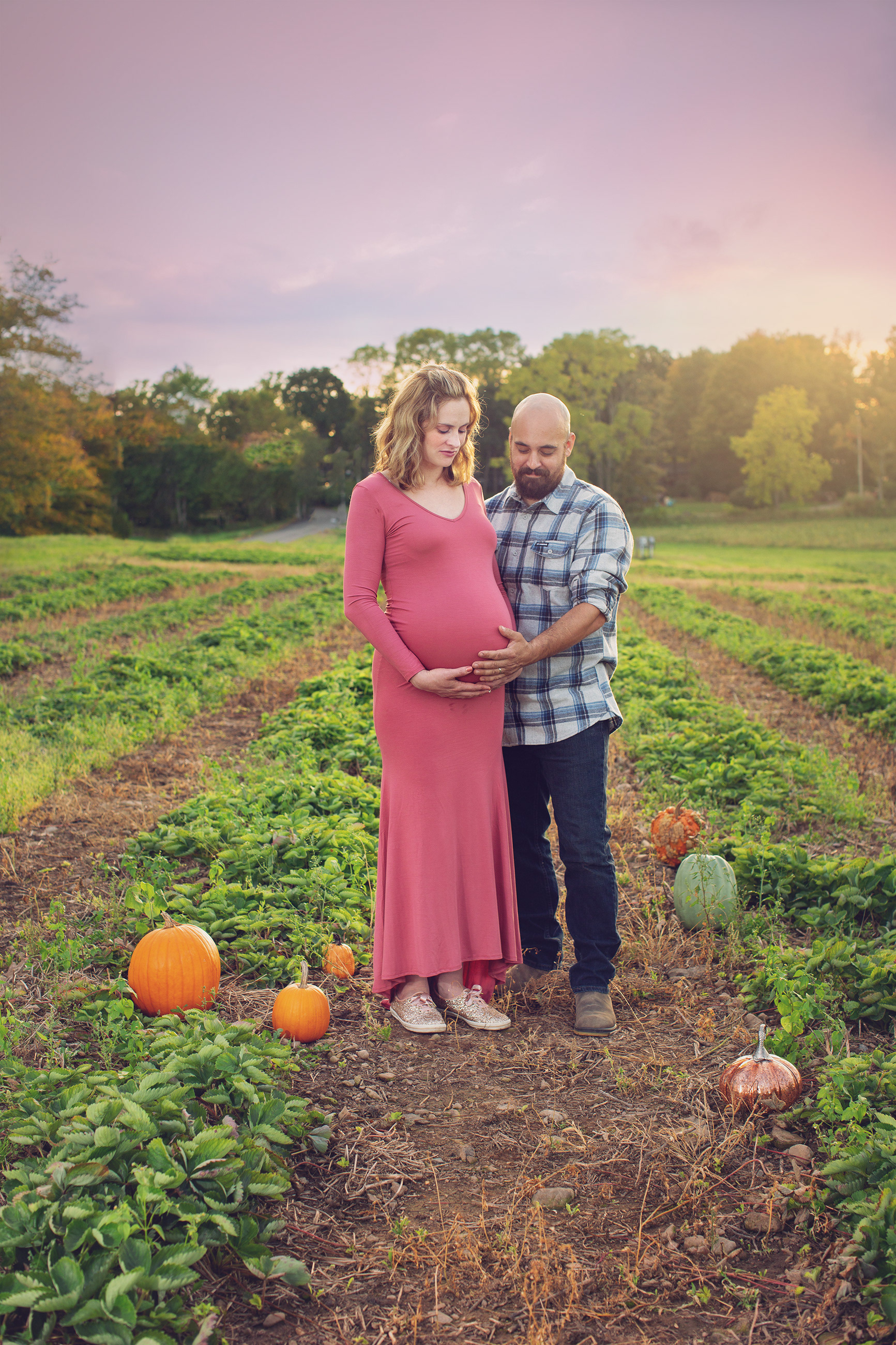 Alexandria, with her husband Russell, pose during her first maternity shoot