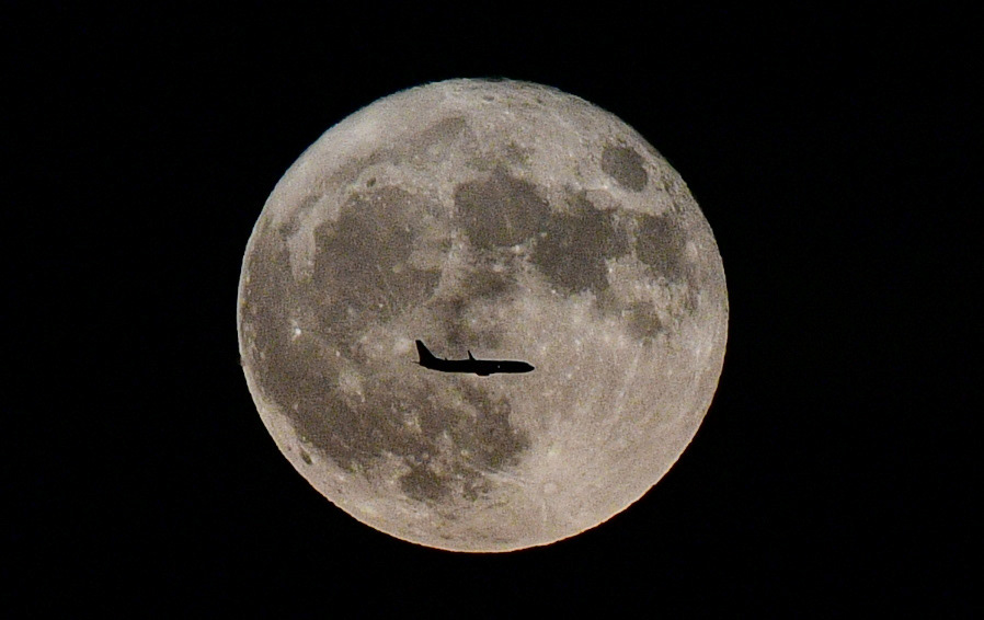 The “Sturgeon Supermoon” rises behind Nashville International Airports arrivals in Nashville, Tenn., Tuesday, Aug. 1, 2023.