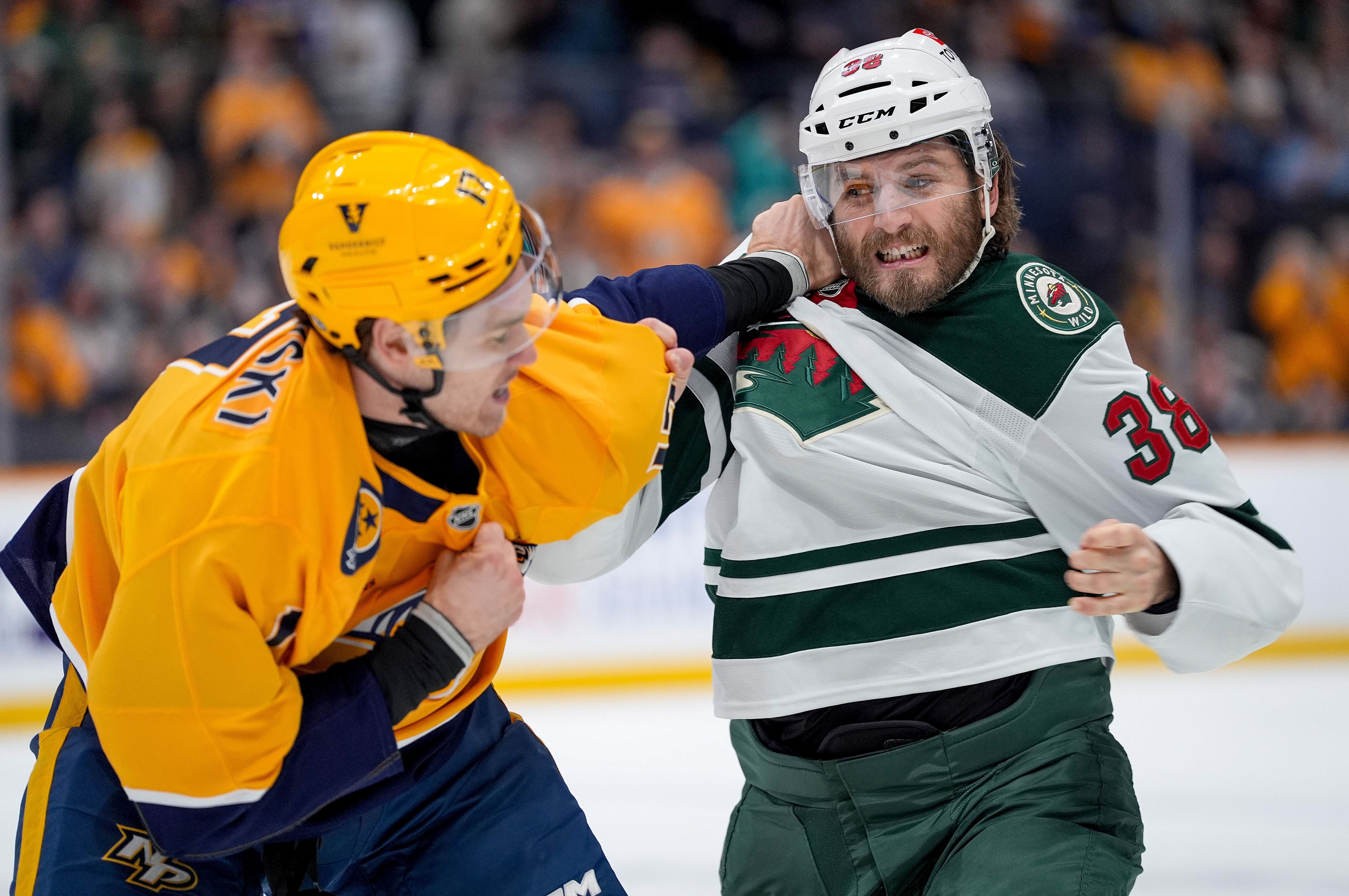 Nashville Predators center Mark Jankowski (17) and Minnesota Wild right wing Ryan Hartman (38) fight during the first period at Bridgestone Arena in Nashville, Tenn., Saturday, Jan. 18, 2025.