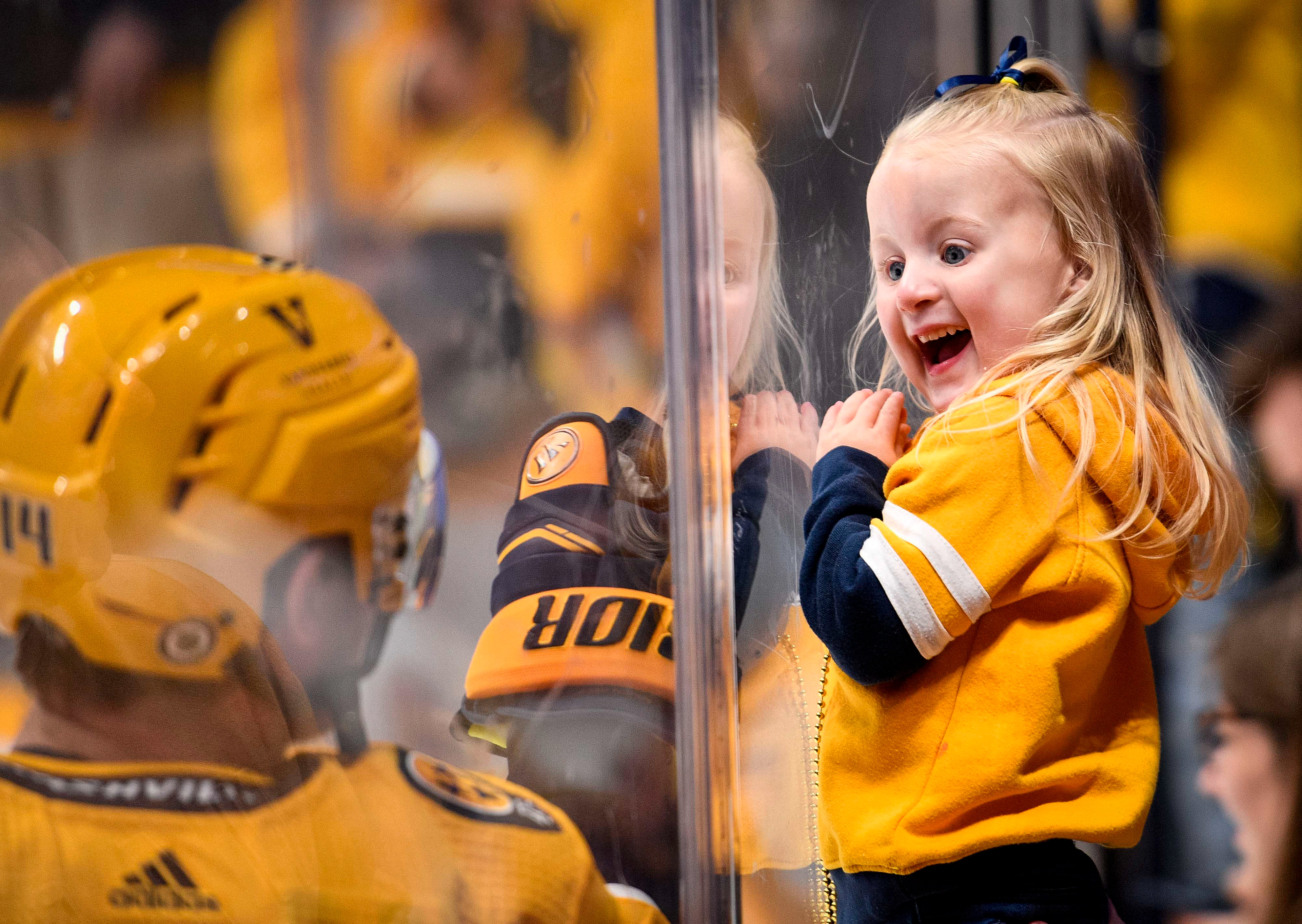 Murphy McDonagh, daughter of Nashville Predators defenseman Ryan McDonagh (27) (not pictured) is surprised by Nashville Predators center Gustav Nyquist (14) before an NHL hockey game between the Jets and Predators at Bridgestone Arena in Nashville, Tenn., Tuesday, April 9, 2024. 