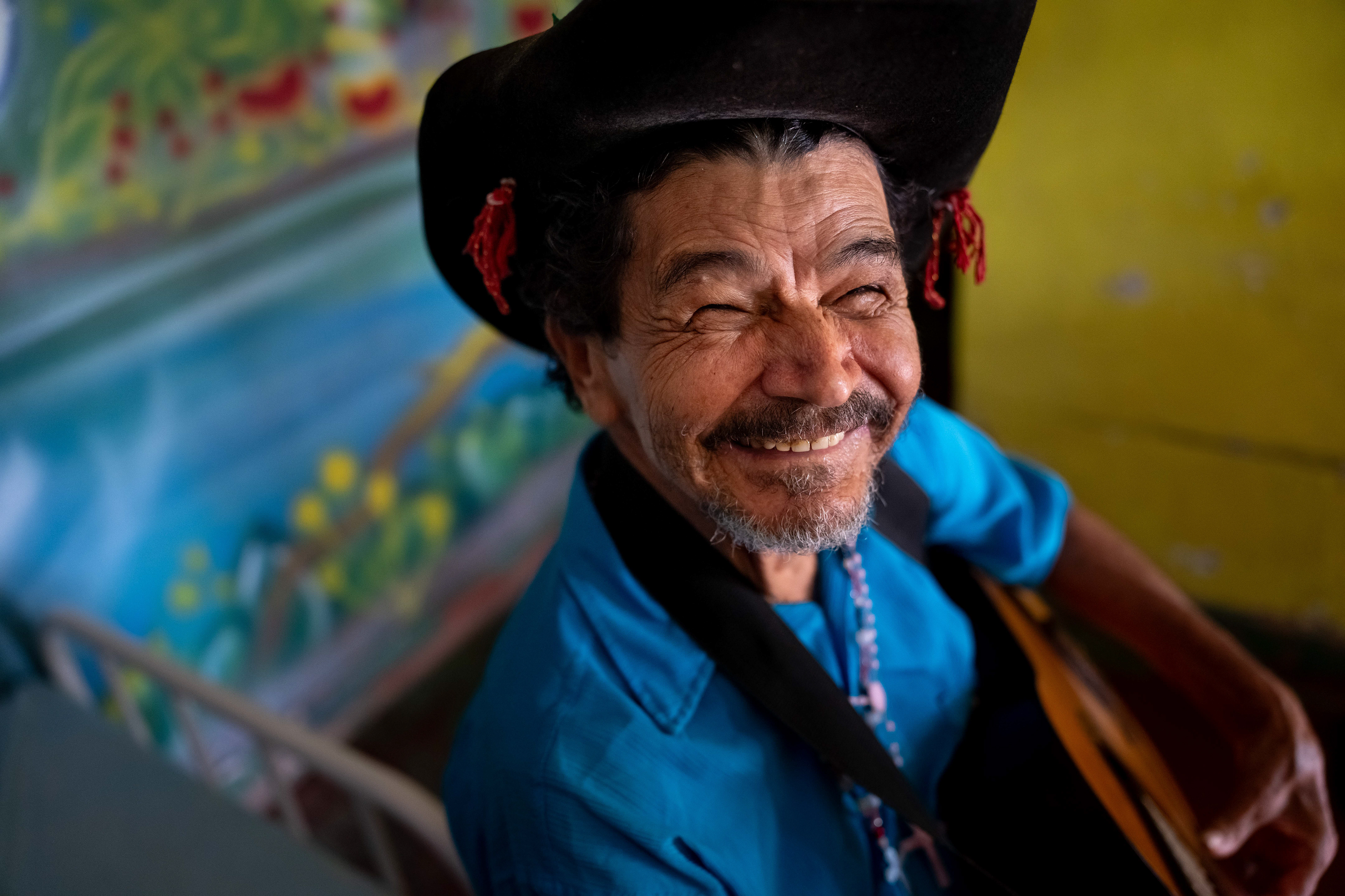 Pipa poses for a photograph in his room at the Saint Vincent de Paul Home in Cidade de Goiás, Go., Friday, March 6, 2026. Living with an intellectual disability, he often turns to music as a way to spend his time. (© Camden Hall)