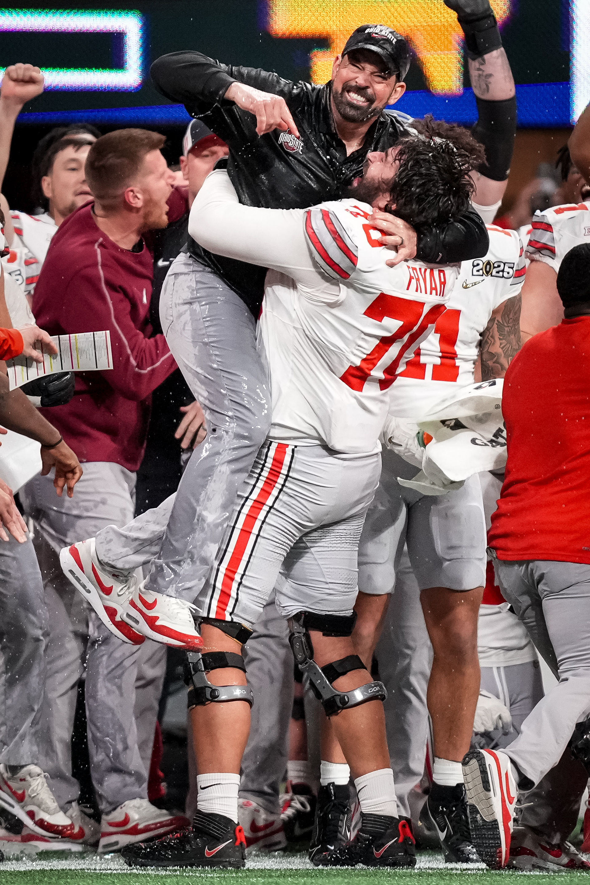 Ohio State head coach Ryan Day celebrates with Ohio State’s defensive linemen Josh Fryar (70) after defeating the Notre Dame Fighting Irish 34-23 to win the 2025 College Football National Championship at Mercedes-Benz Stadium in Atlanta, GA., Monday, January 20, 2025.