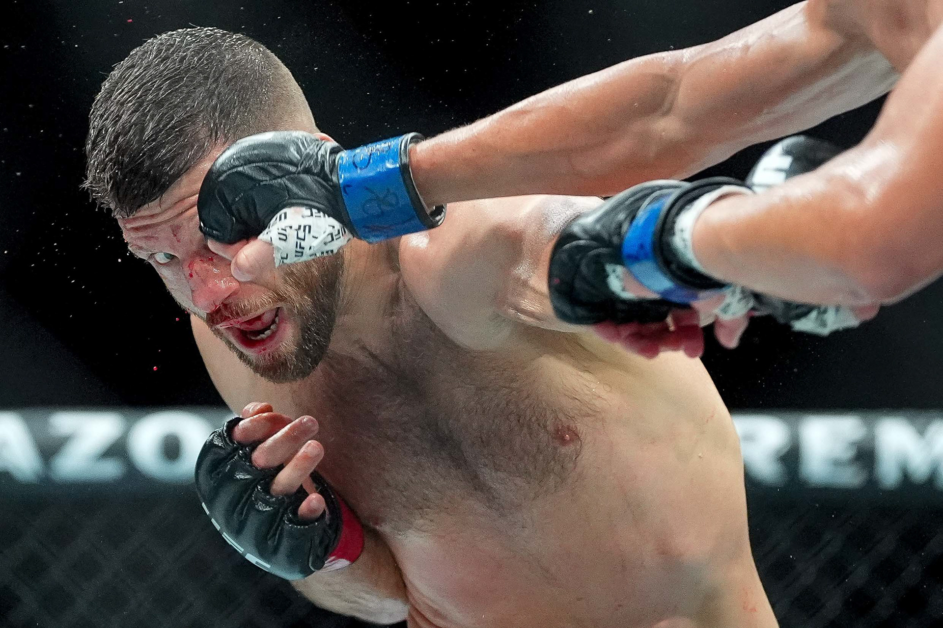 Calvin Kattar, left, is punched by Steve Garcia during a featherweight match during UFC Fight Night at Bridgestone Arena in Nashville, Tenn., Saturday, July 12, 2025.