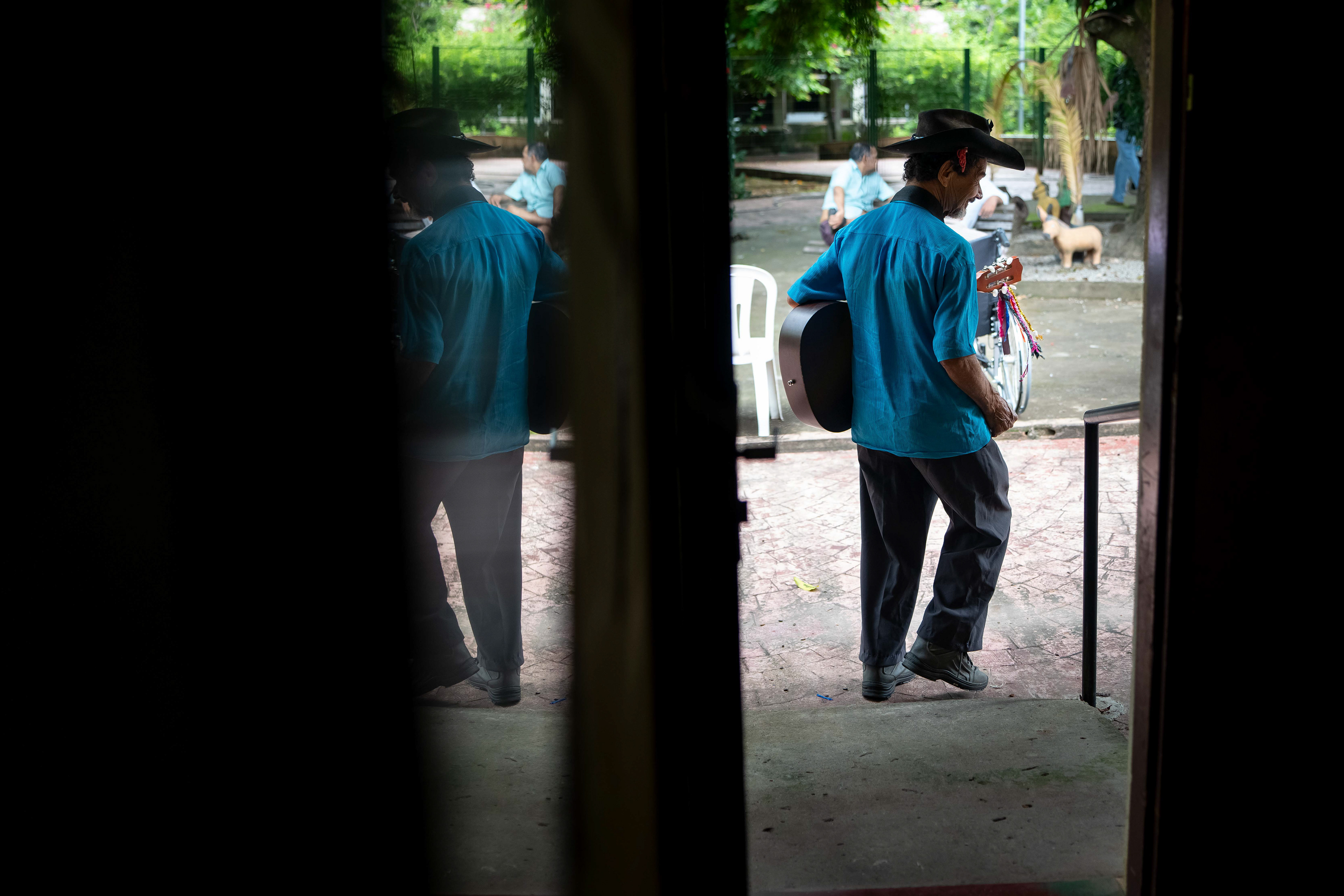 Pipa heads out of his room at the Saint Vincent de Paul Home in Cidade de Goiás, Go., Friday, March 6, 2026. Living with an intellectual disability, he often turns to music as a way to spend his time.