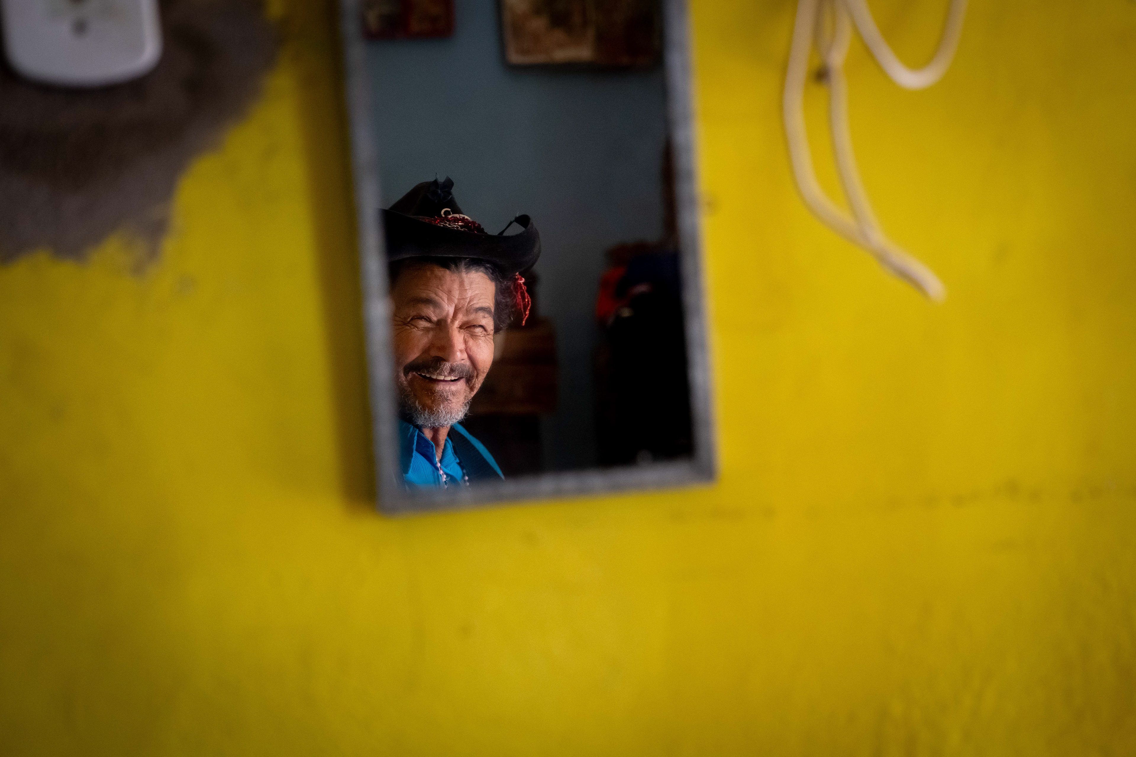 Pipa poses for a photograph in his room at the Saint Vincent de Paul Home in Cidade de Goiás, Go., Friday, March 6, 2026. Living with an intellectual disability, he often turns to music as a way to spend his time. (© Camden Hall)