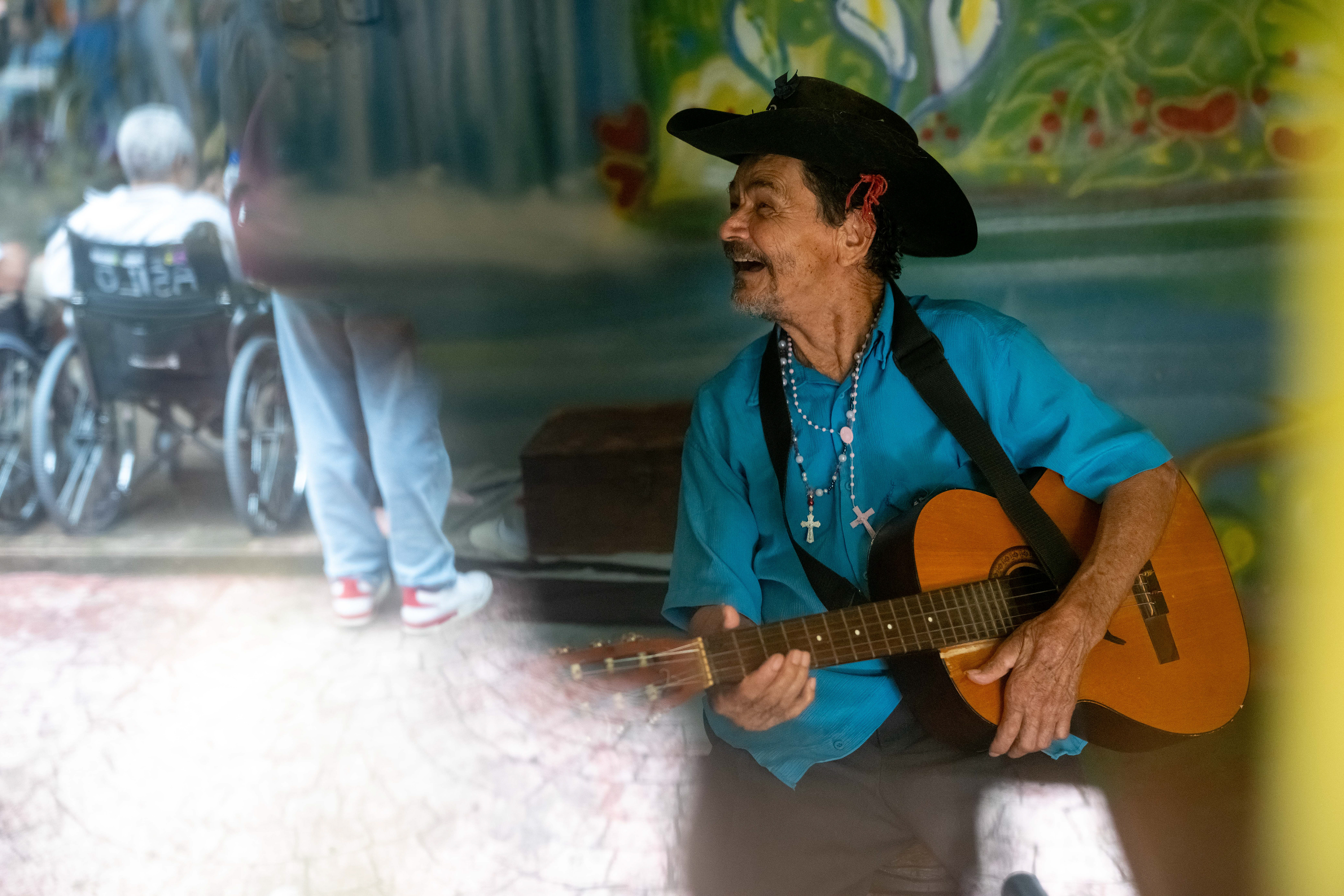 Pipa plays his guitar in his room at the Saint Vincent de Paul Home in Cidade de Goiás, Go., Friday, March 6, 2026. Living with an intellectual disability, he often turns to music as a way to spend his time. (© Camden Hall)