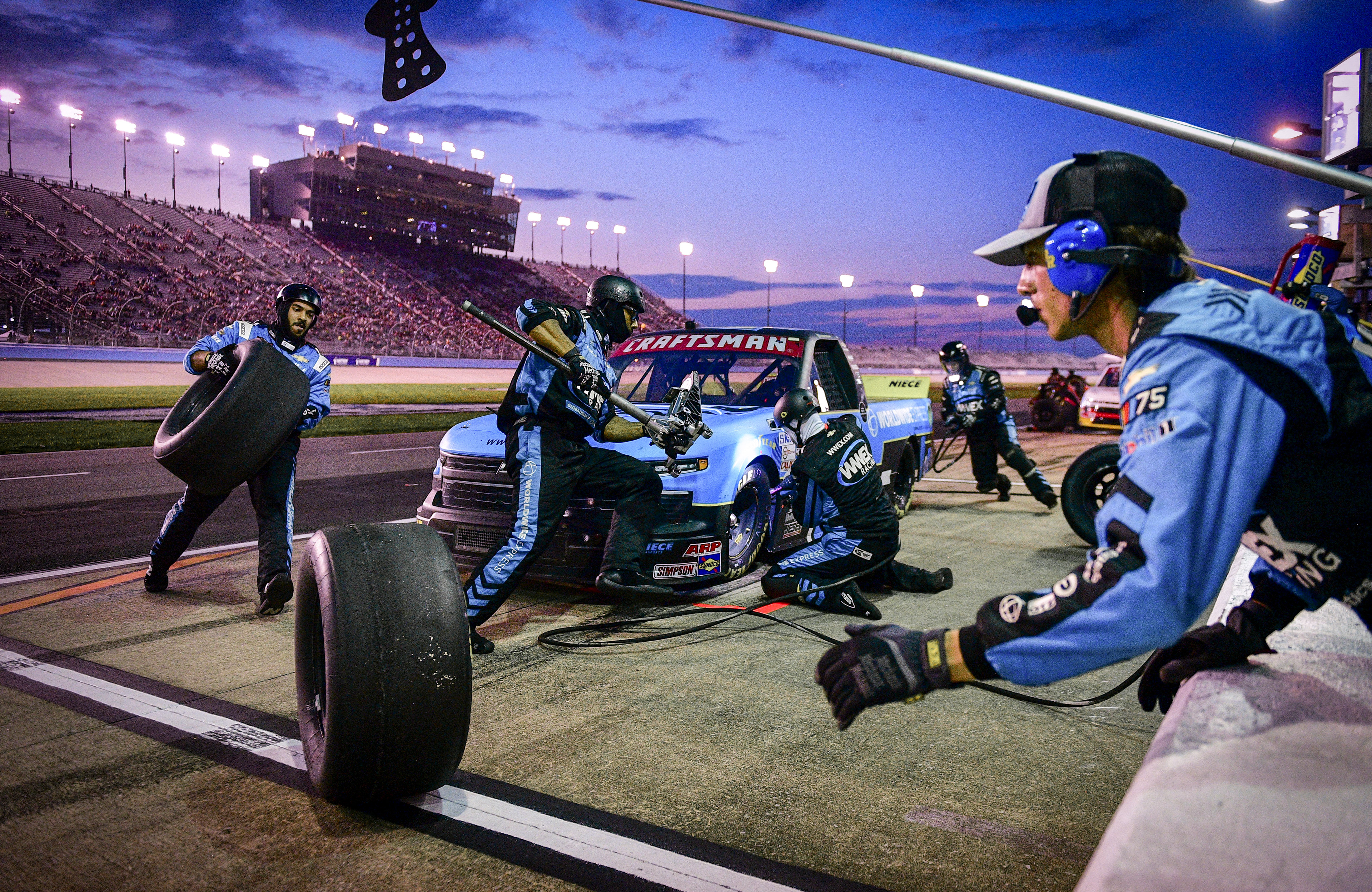 A NASCAR truck has its tires changed during a pit stop on the Ally 400 race weekend at Nashville Superspeedway in Lebanon, Tenn., Friday, June 23, 2023.