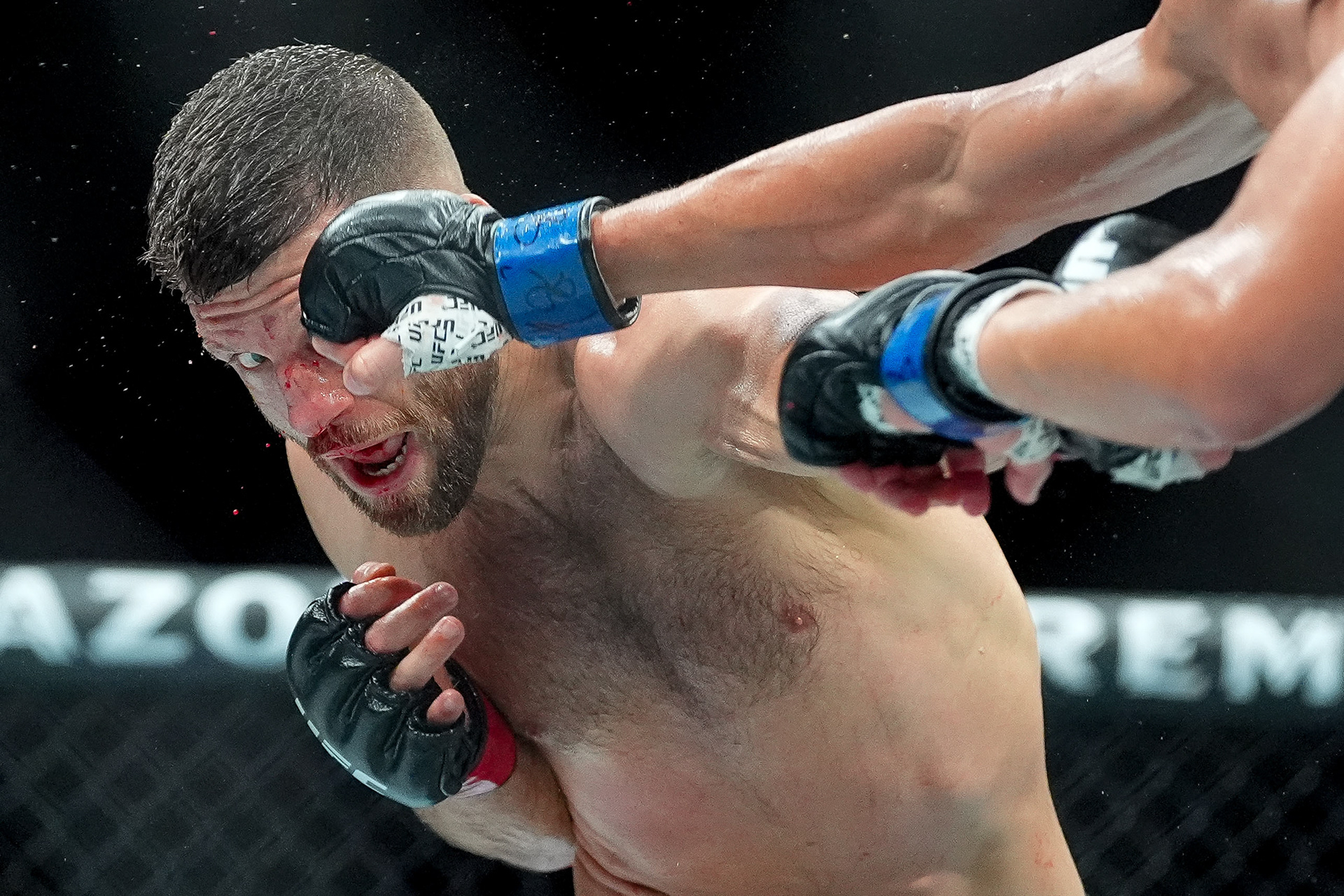 Calvin Kattar, left, is punched by Steve Garcia during a featherweight match during UFC Fight Night at Bridgestone Arena in Nashville, Tenn., Saturday, July 12, 2025. 