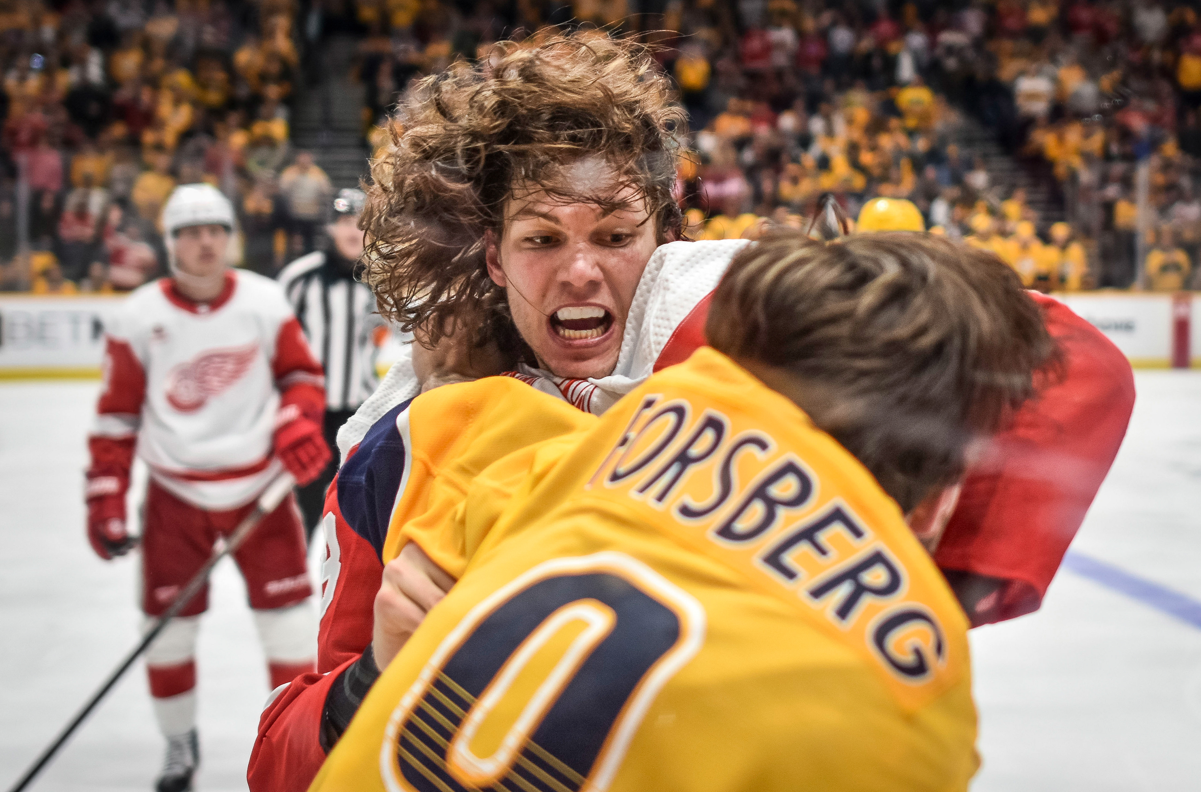 A fight breaks out between Detroit Red Wings defenseman Moritz Seider (53) and Nashville Predators left wing Filip Forsberg (9) during the second period of their NHL hockey game at Bridgestone Arena in Nashville, Tenn., Saturday, March 23, 2024. 