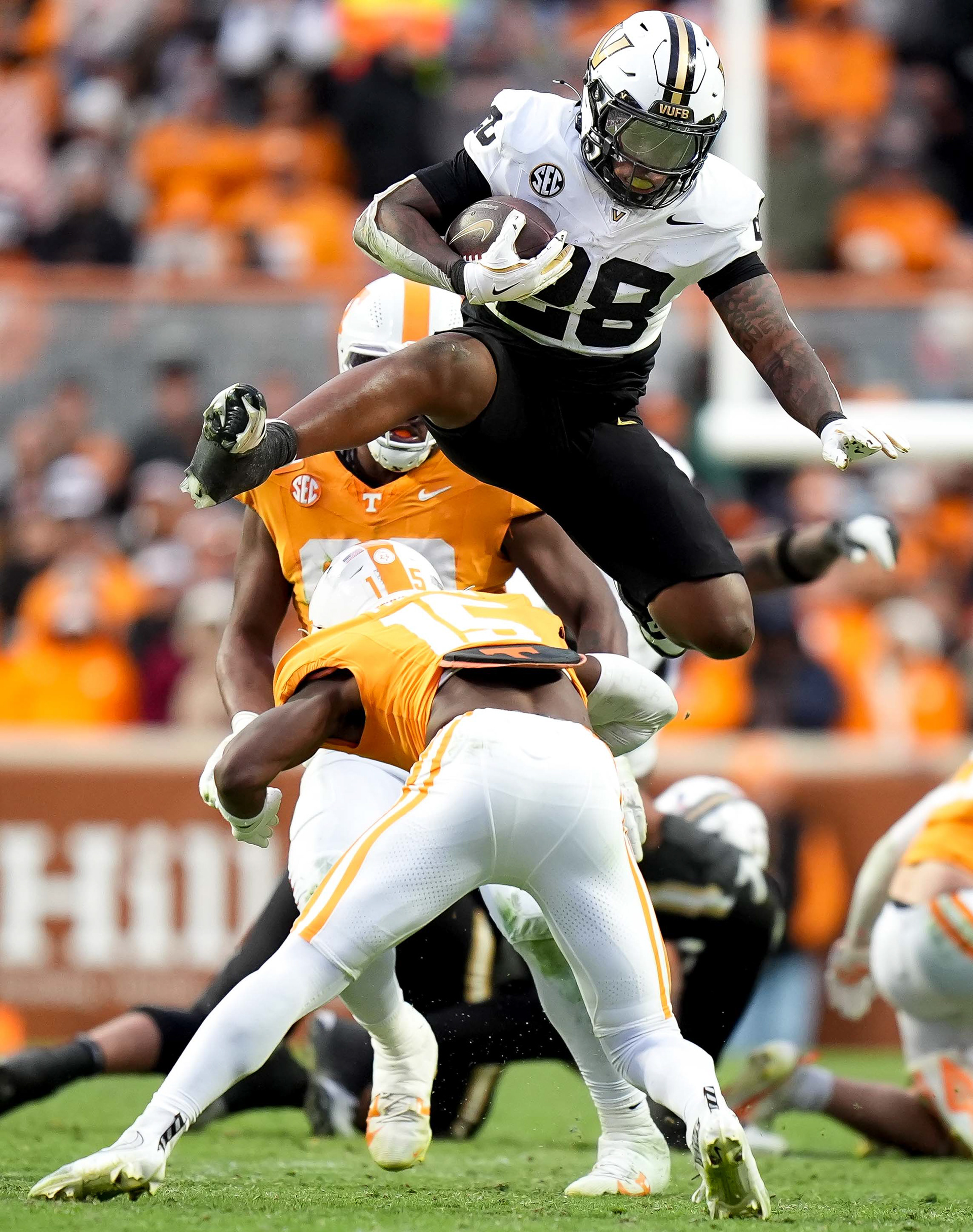 Vanderbilt running back Sedrick Alexander (28) hurdles Tennessee defensive back Edrees Farooq (15) during the second quarter at Neyland Stadium in Knoxville, Tenn., Saturday, Nov. 29, 2025.