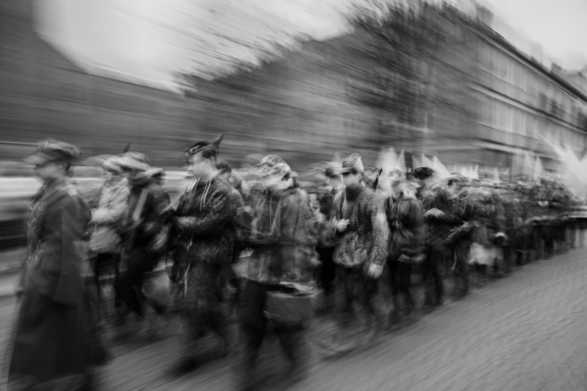 Black and white ICM photography of soldiers marching in formation on a city street, capturing motion blur and a historical atmosphere.