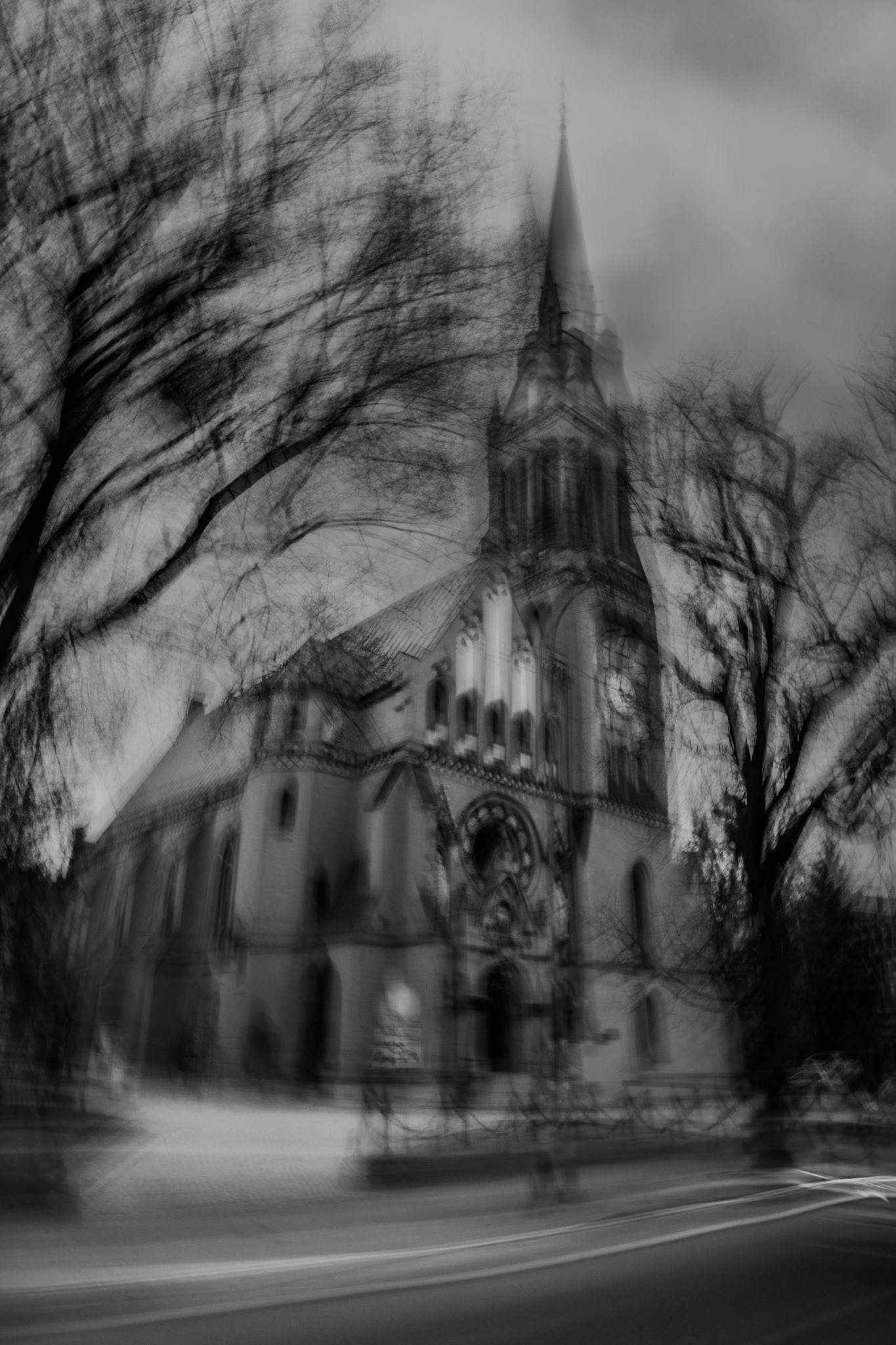 Abstract black and white long-exposure photograph of a Gothic church using Intentional Camera Movement (ICM) to create a ghostly, ethereal atmosphere.