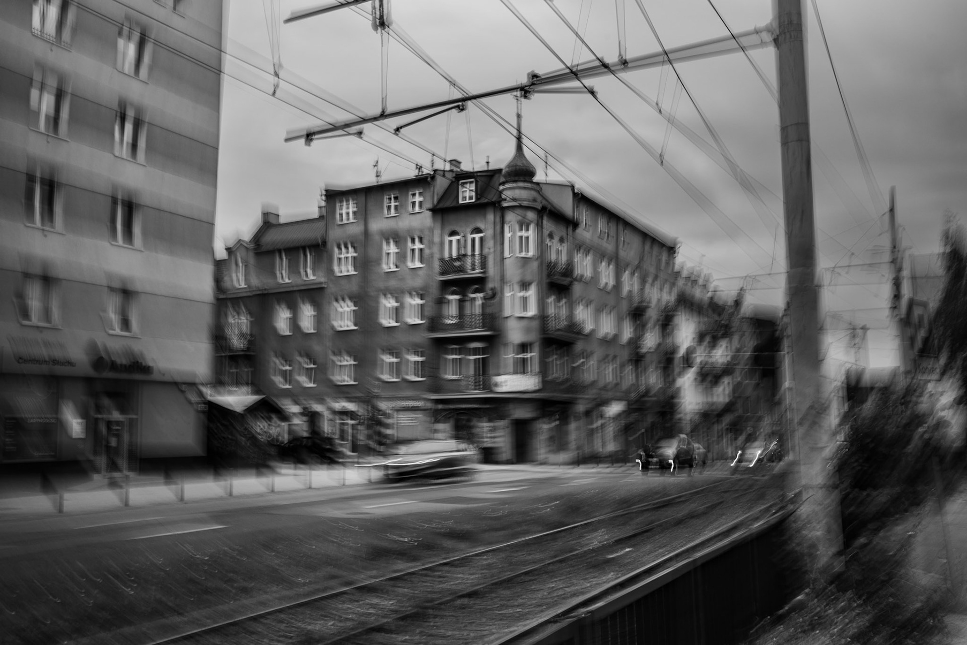A photography of street view with tram rails and apartment house made in ICM technique
